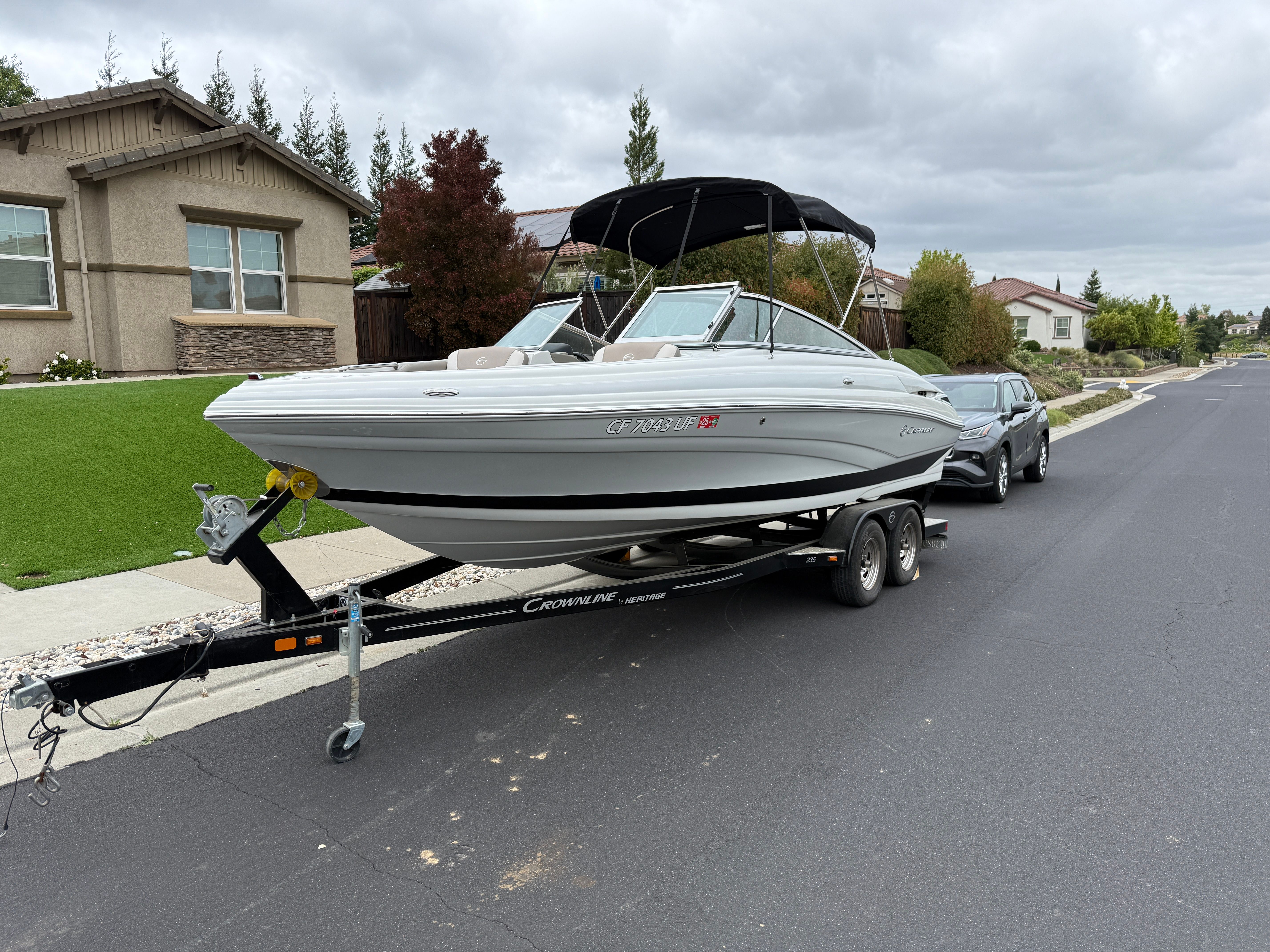 2019 Crownline 235 SS boat on trailer in residential area.