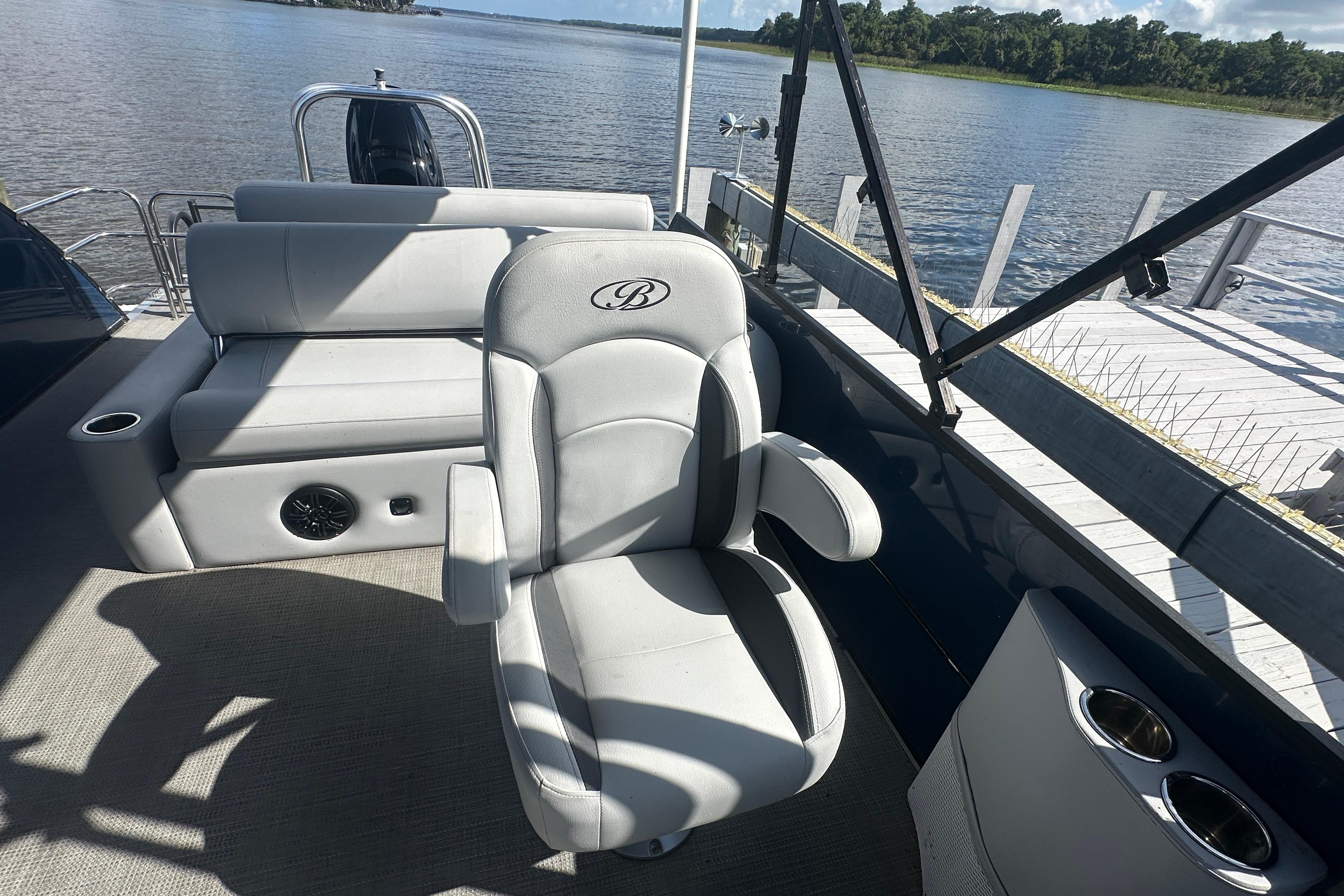2023 Bentley Pontoons Legacy 243 Swingback interior with luxurious seating by the water.