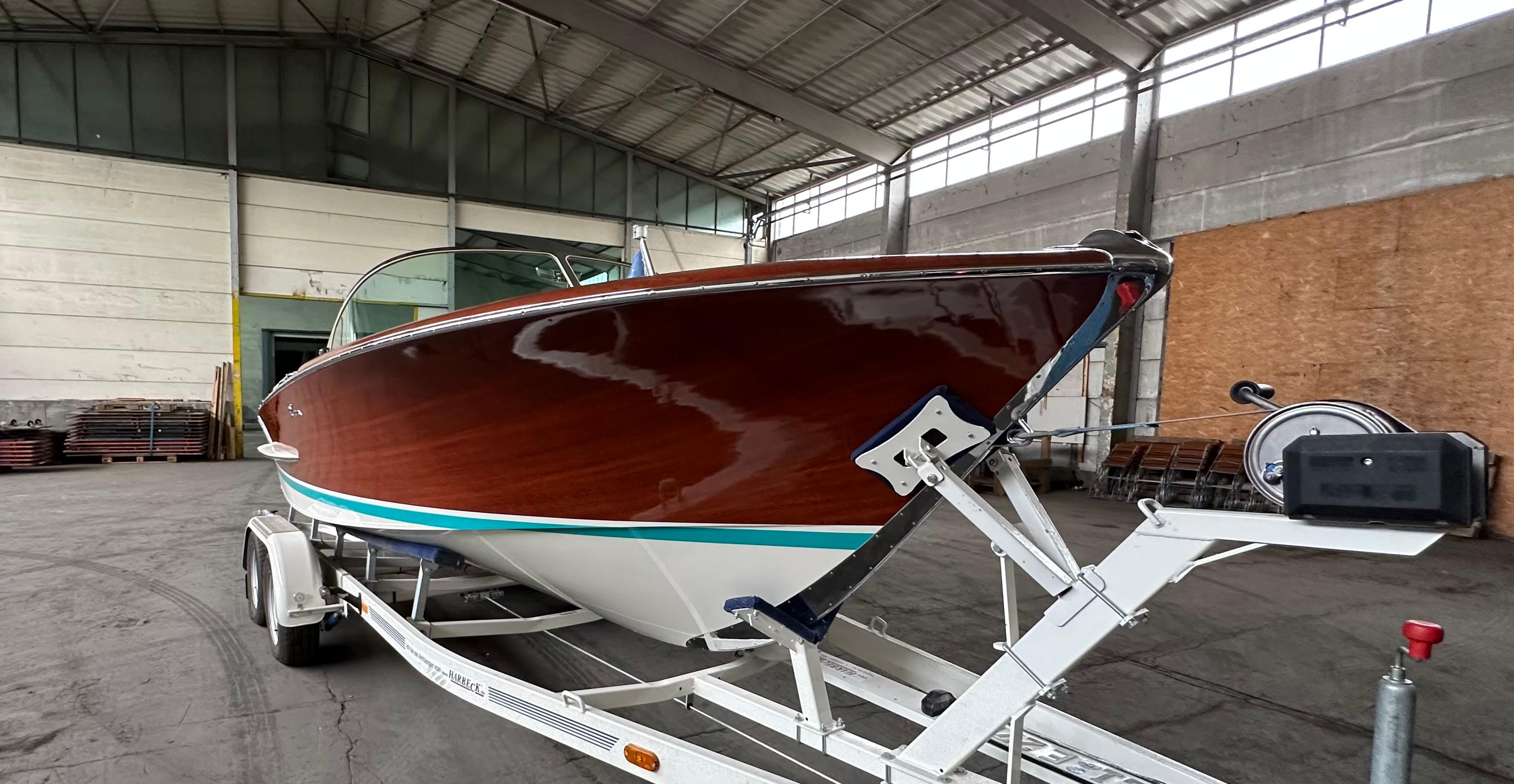 1970 Riva Olympic boat on trailer in warehouse setting.