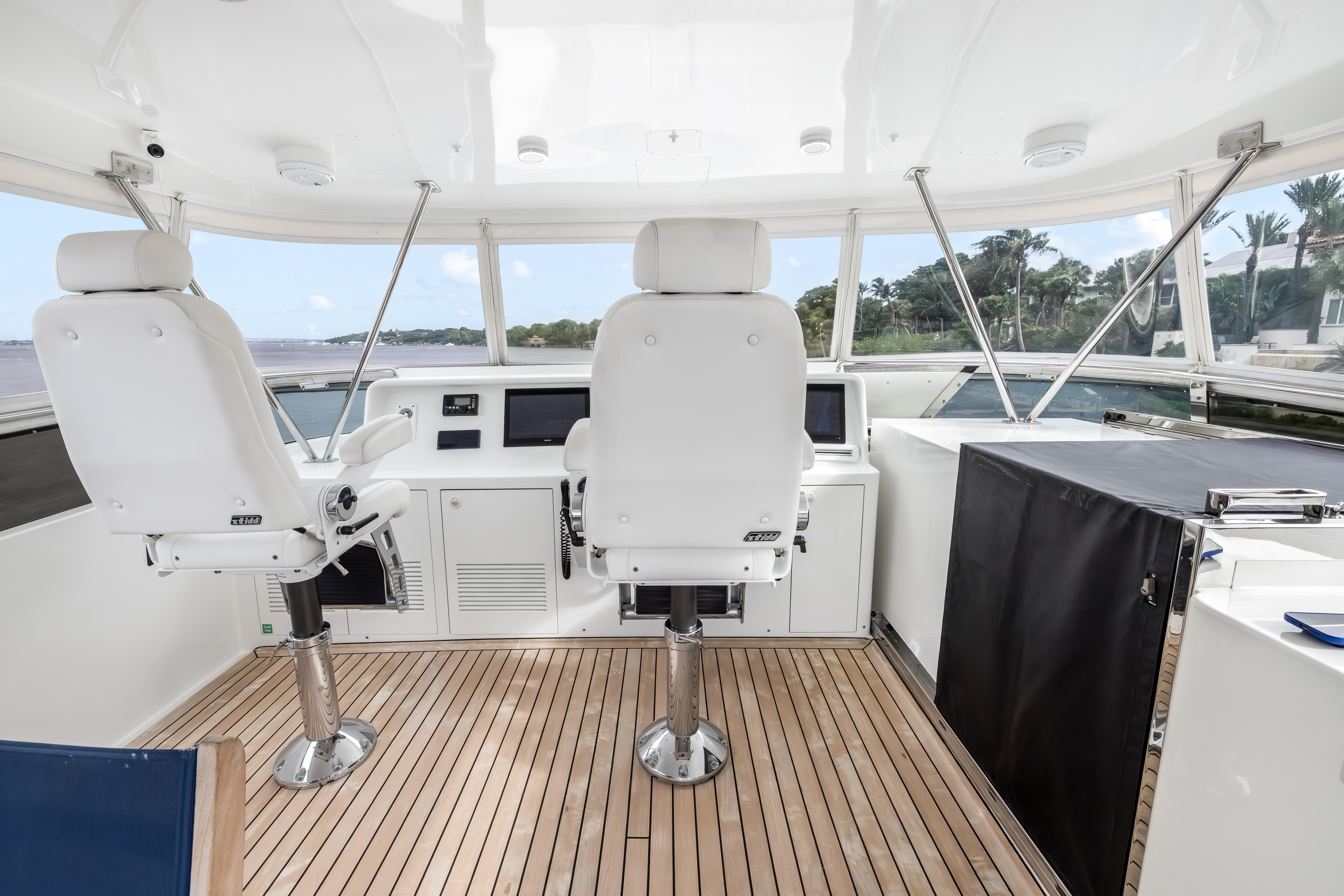 Interior helm of 2012 Cheoy Lee 84 Bravo yacht with dual captain chairs.
