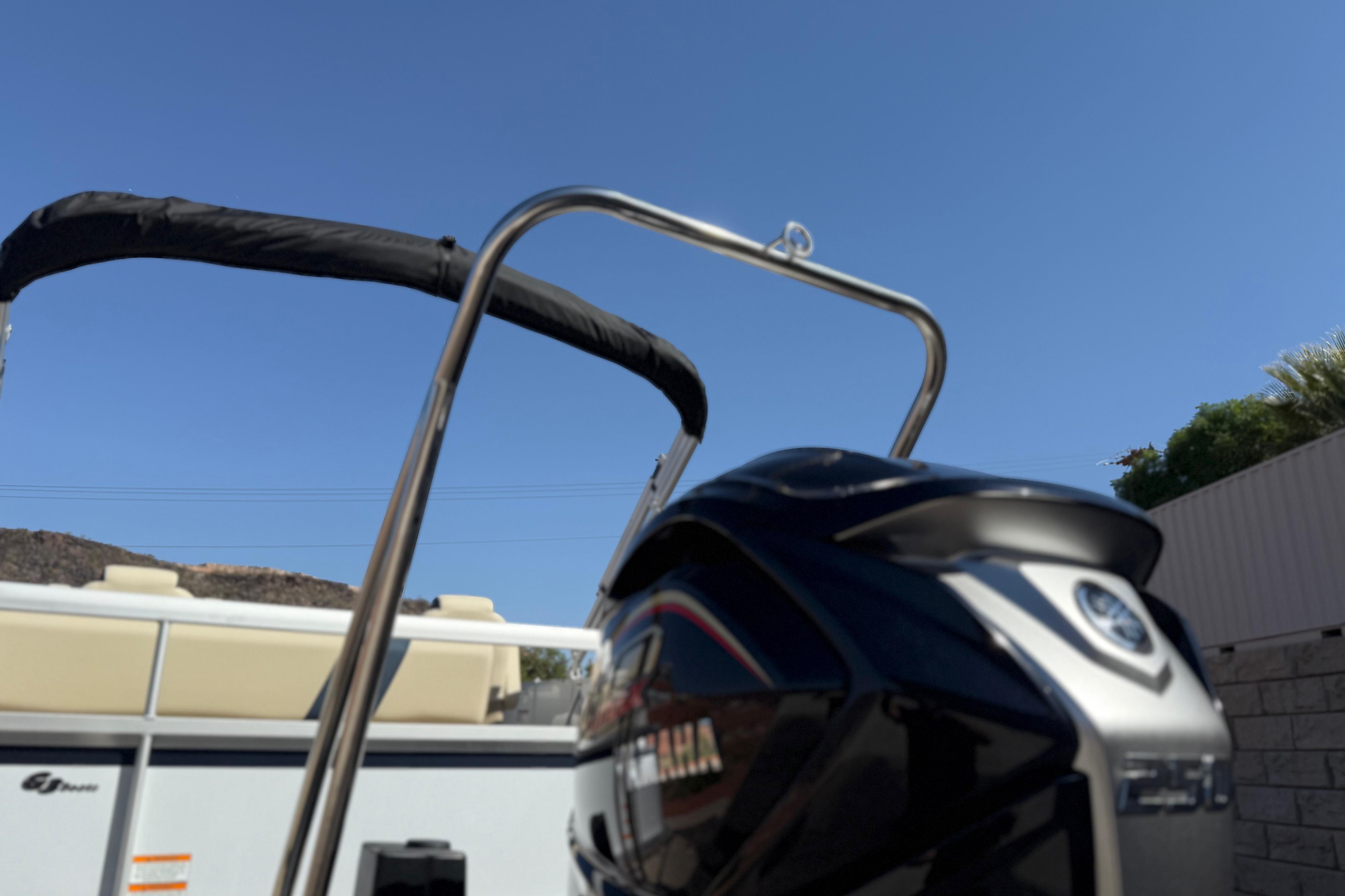 2026 SunCatcher Select 322SL boat with Yamaha engine, clear blue sky background.