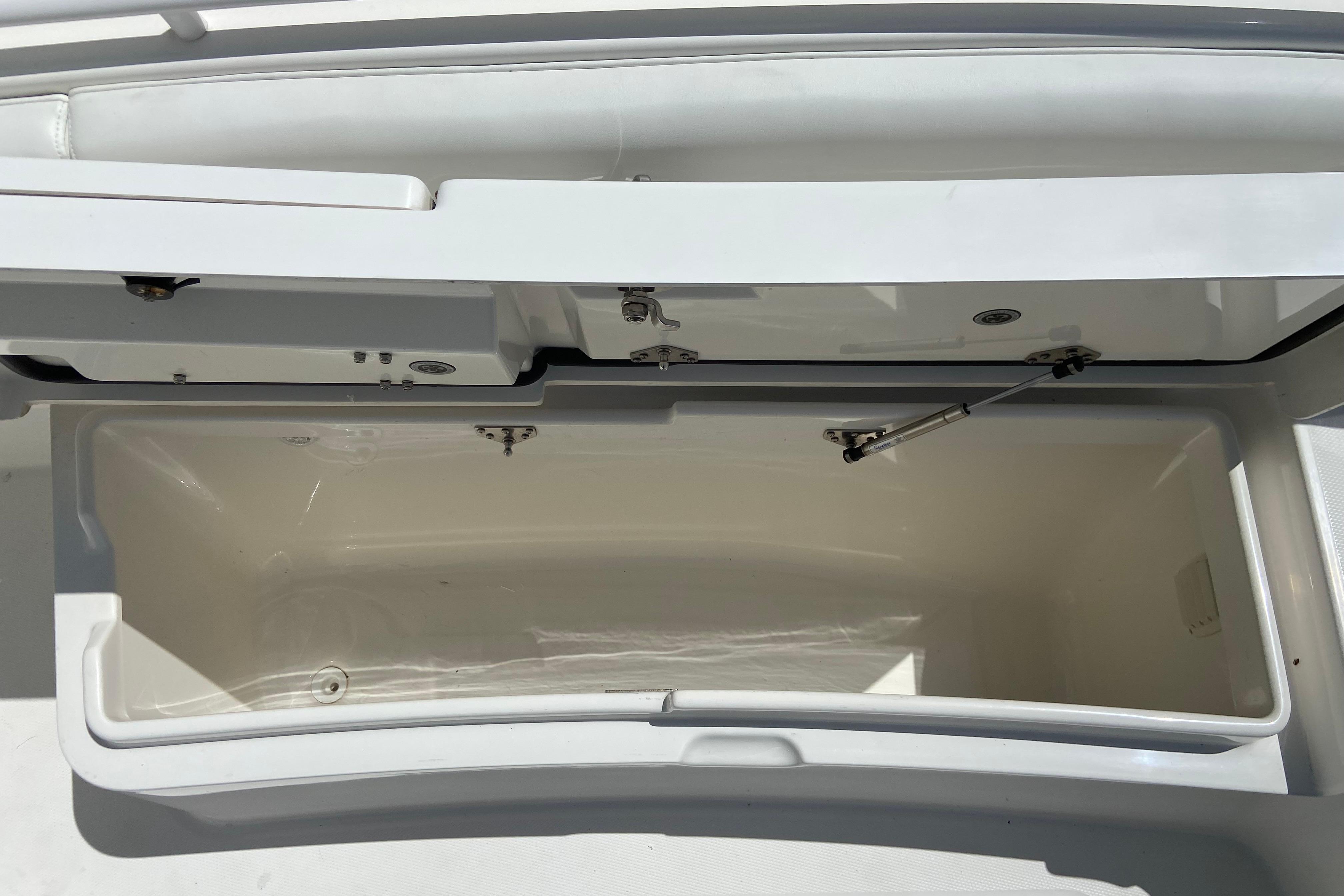 Open storage compartment on a 2021 Regulator 28 boat, showcasing interior space.