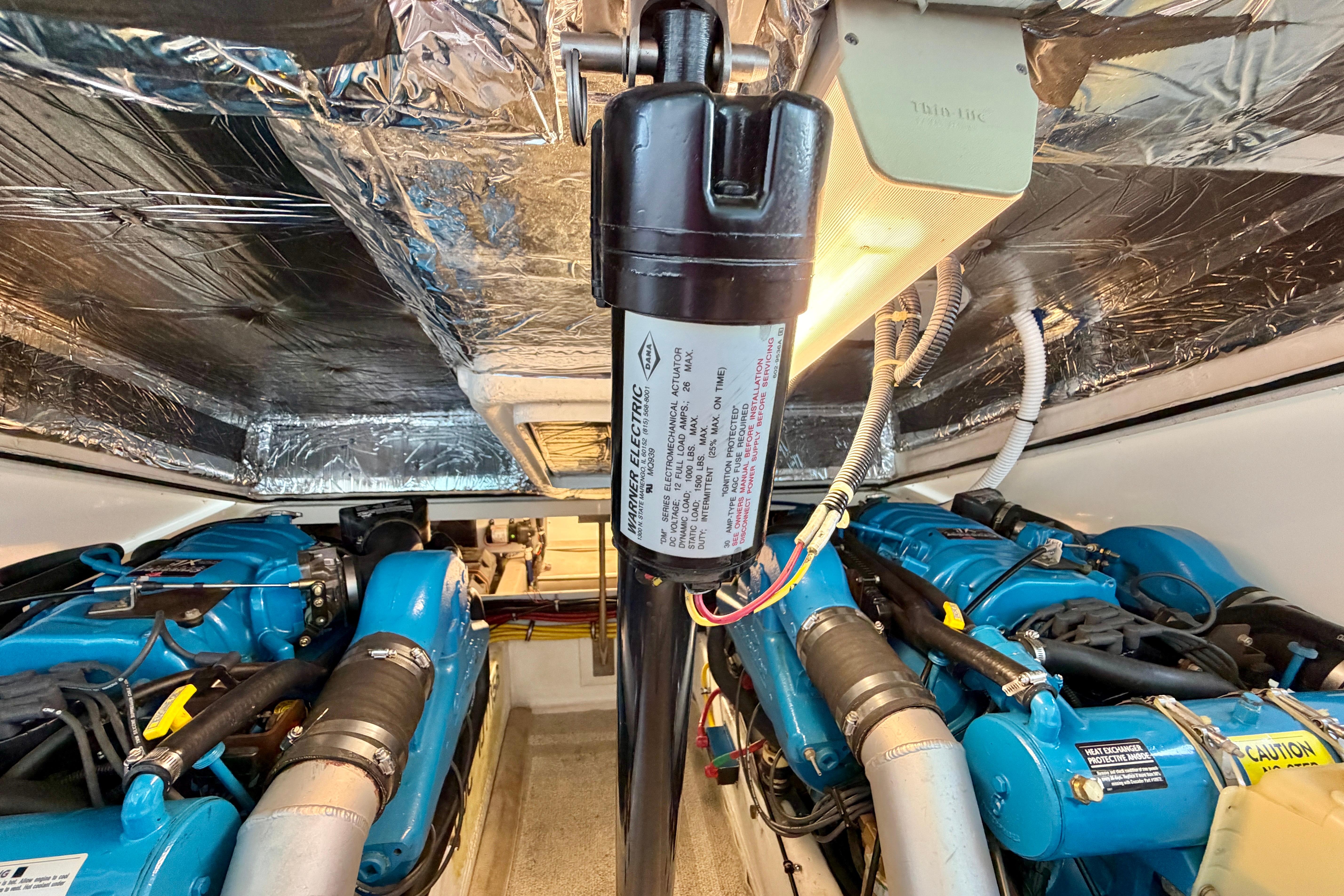 Engine room of 1999 Tiara Yachts 2900 Coronet with blue engines and wiring.
