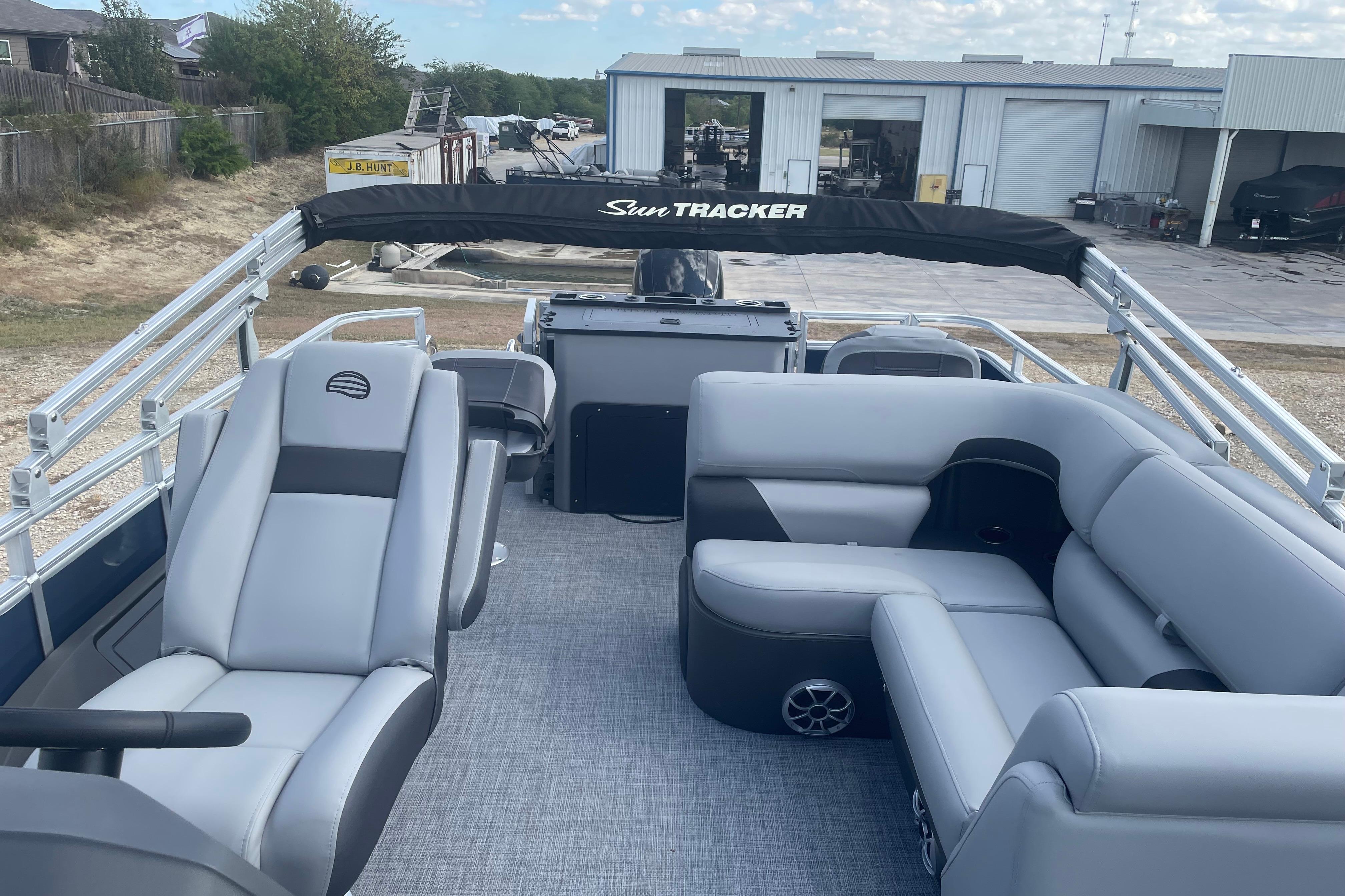 2026 Sun Tracker SportFish 22 DLX pontoon boat interior with gray seating and spacious layout.