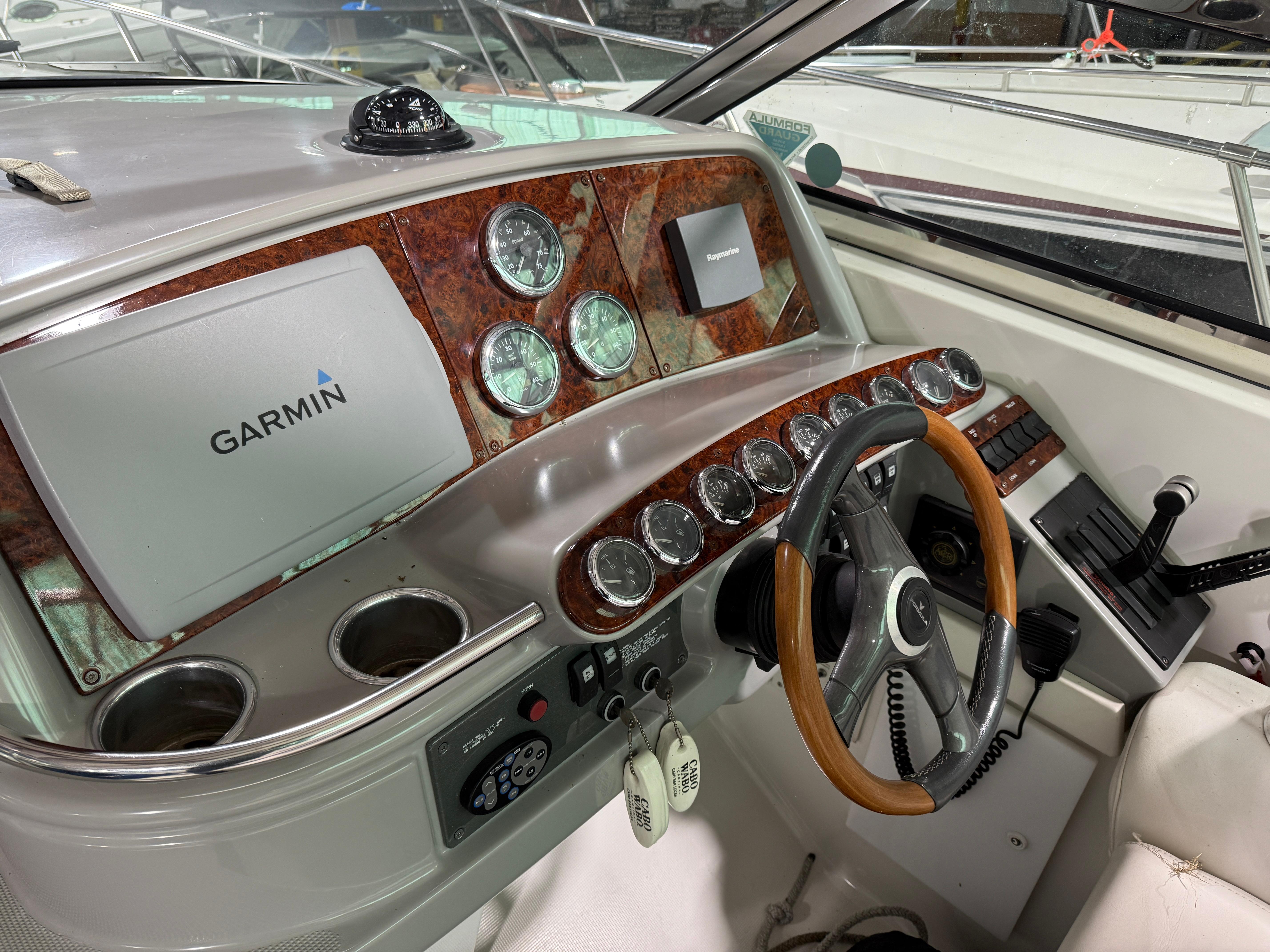 2002 Formula 400 Super Sport boat dashboard with Garmin navigation system and wood accents.