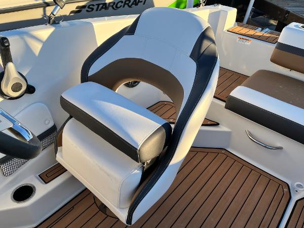 2024 Starcraft SVX 191 boat interior with cushioned seating and wood-like flooring.