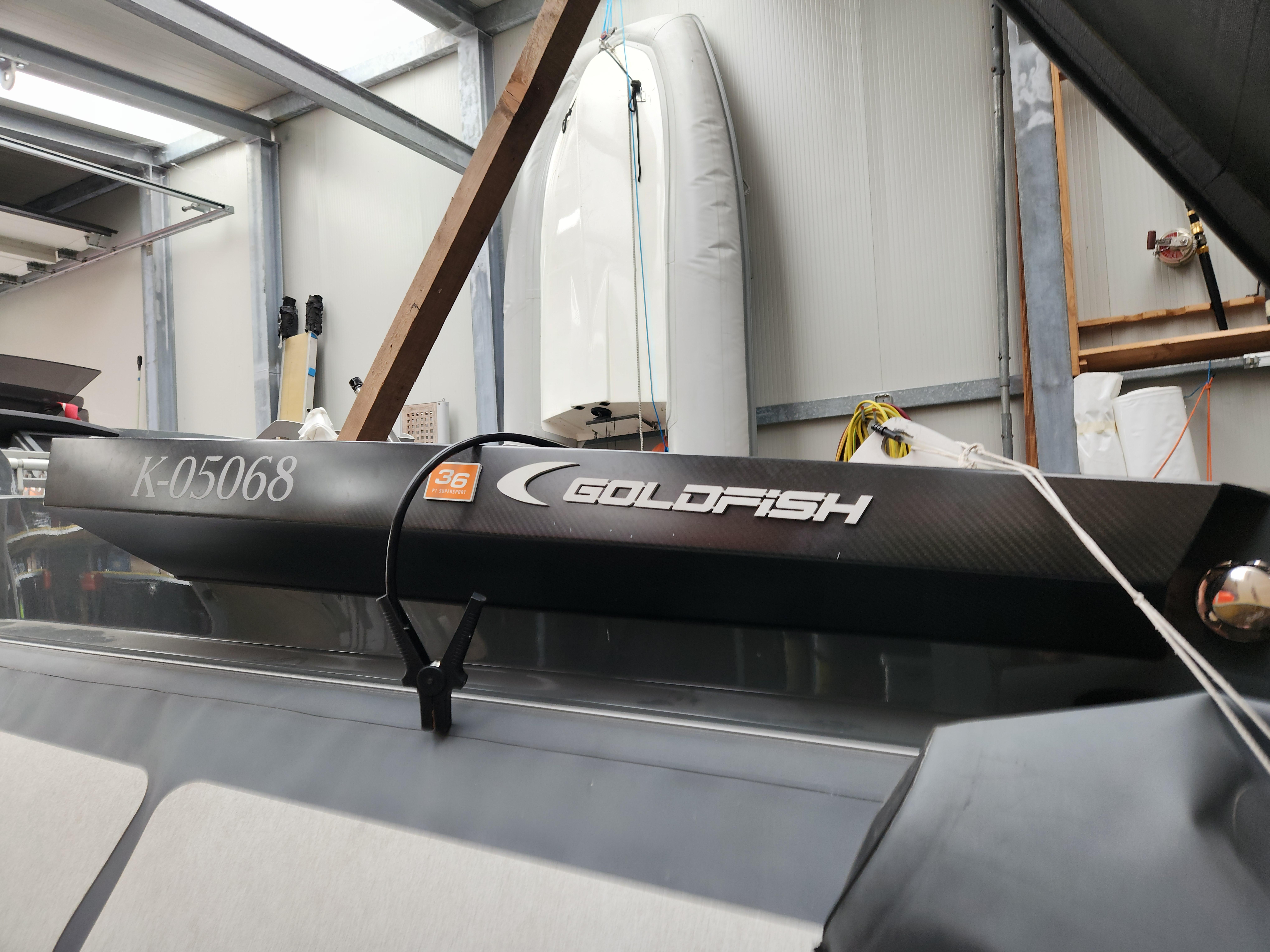 Goldfish 36 P1 SuperSport 2012 boat in a storage facility, showcasing sleek design and branding.