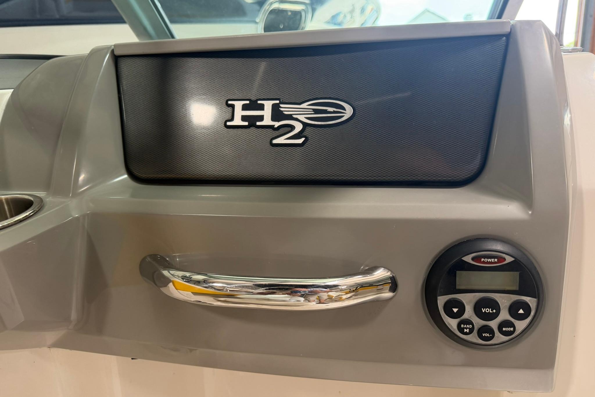 Dashboard of 2012 Chaparral 19 Sport H2O boat with control panel and handle.