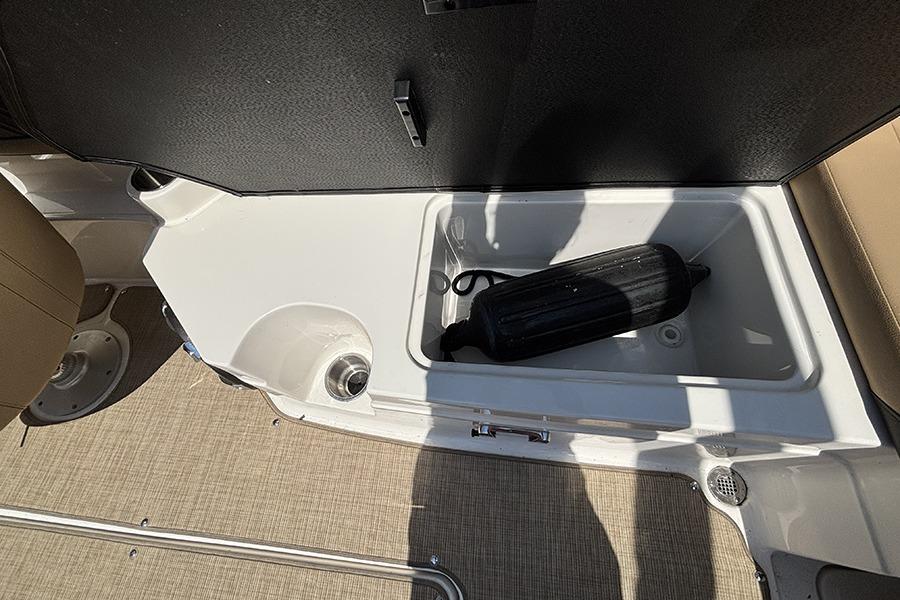 2019 Sea Ray SPX 230 Outboard storage compartment with black fender inside.