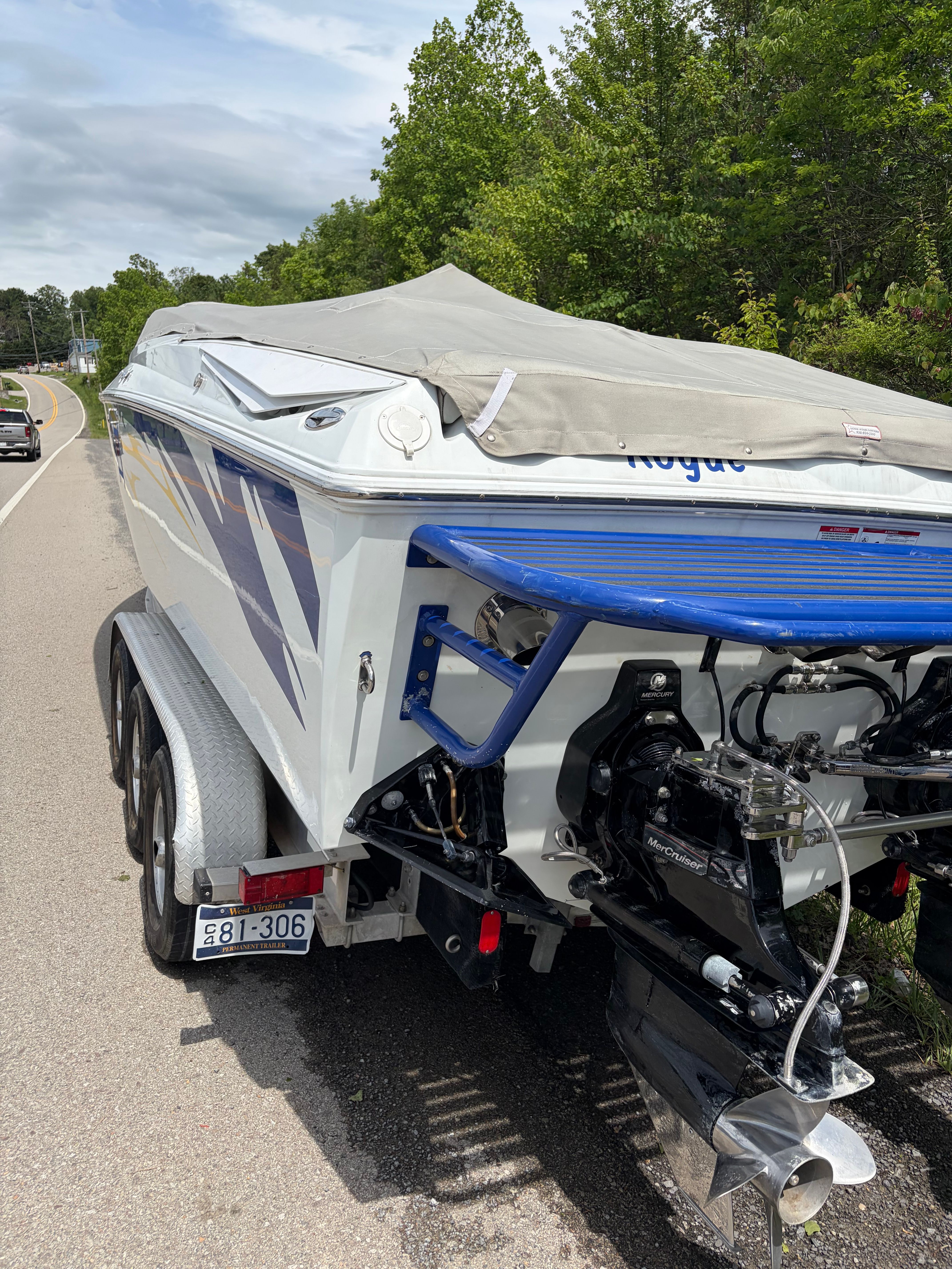 2007 Baja 30 Outlaw boat on trailer by roadside.
