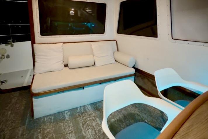 Interior of 1982 Lancer 45 Motorsailer with sofa and modern chairs.