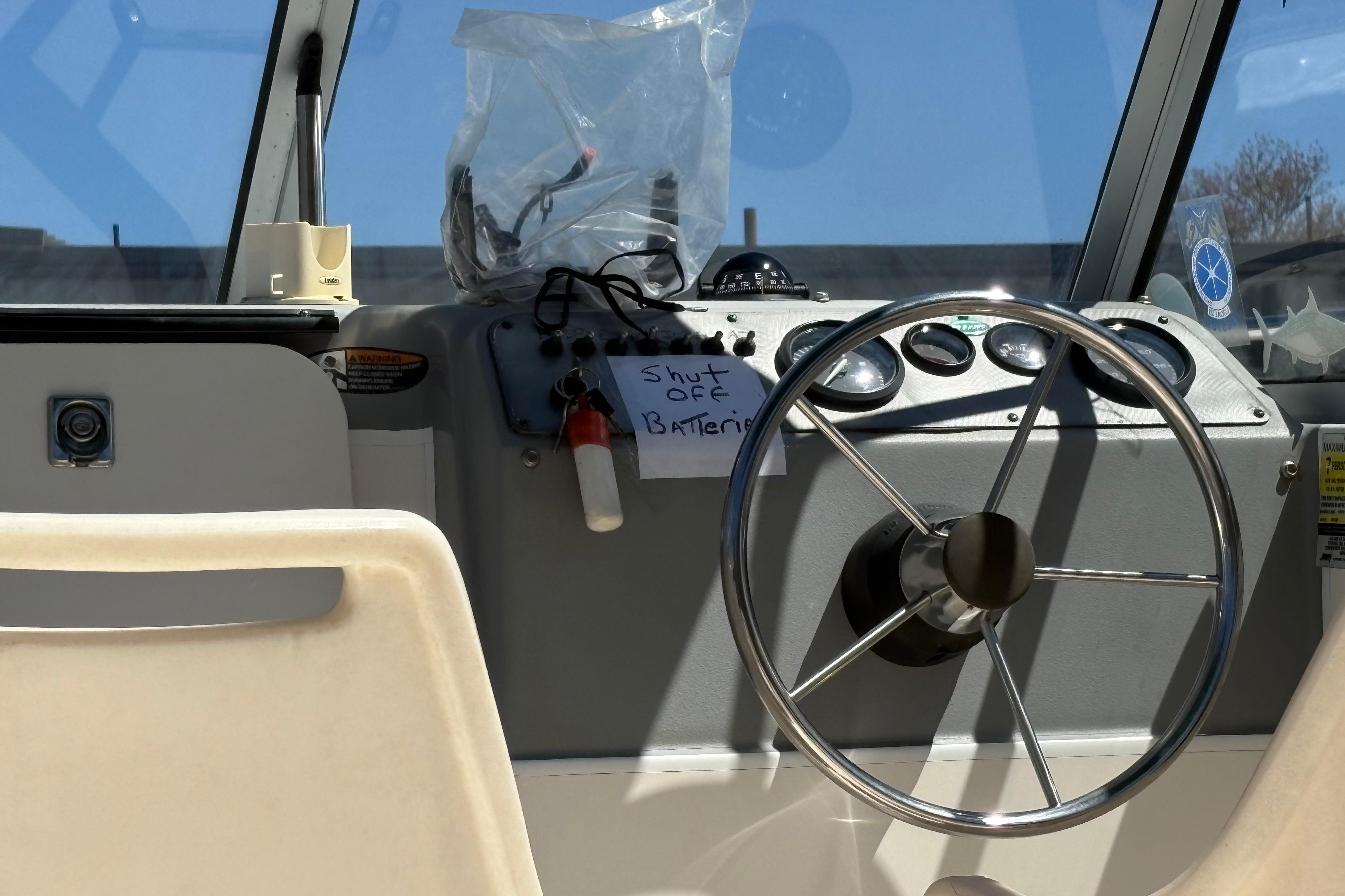 Steering wheel of a 2004 Trophy 1802 Walkaround boat with dashboard controls.
