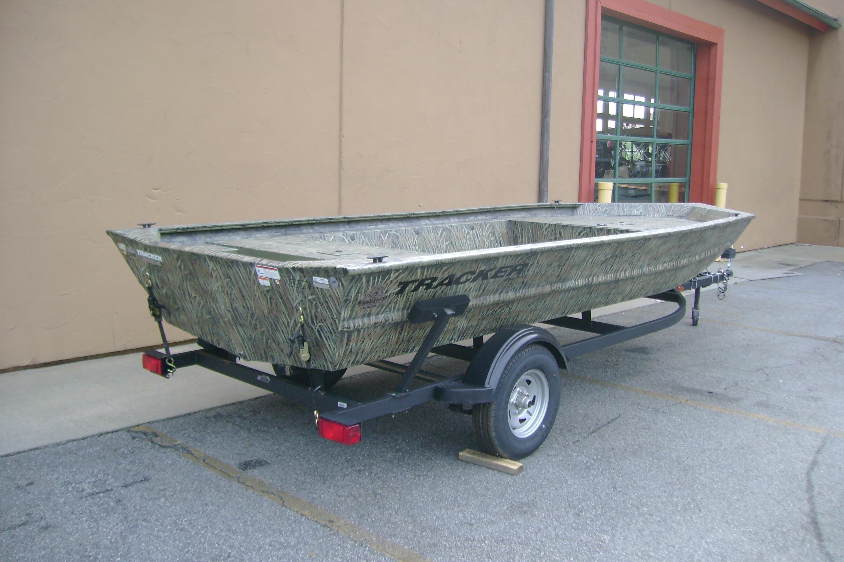 2026 Tracker Grizzly 1754 Utility boat on trailer, parked outdoors.