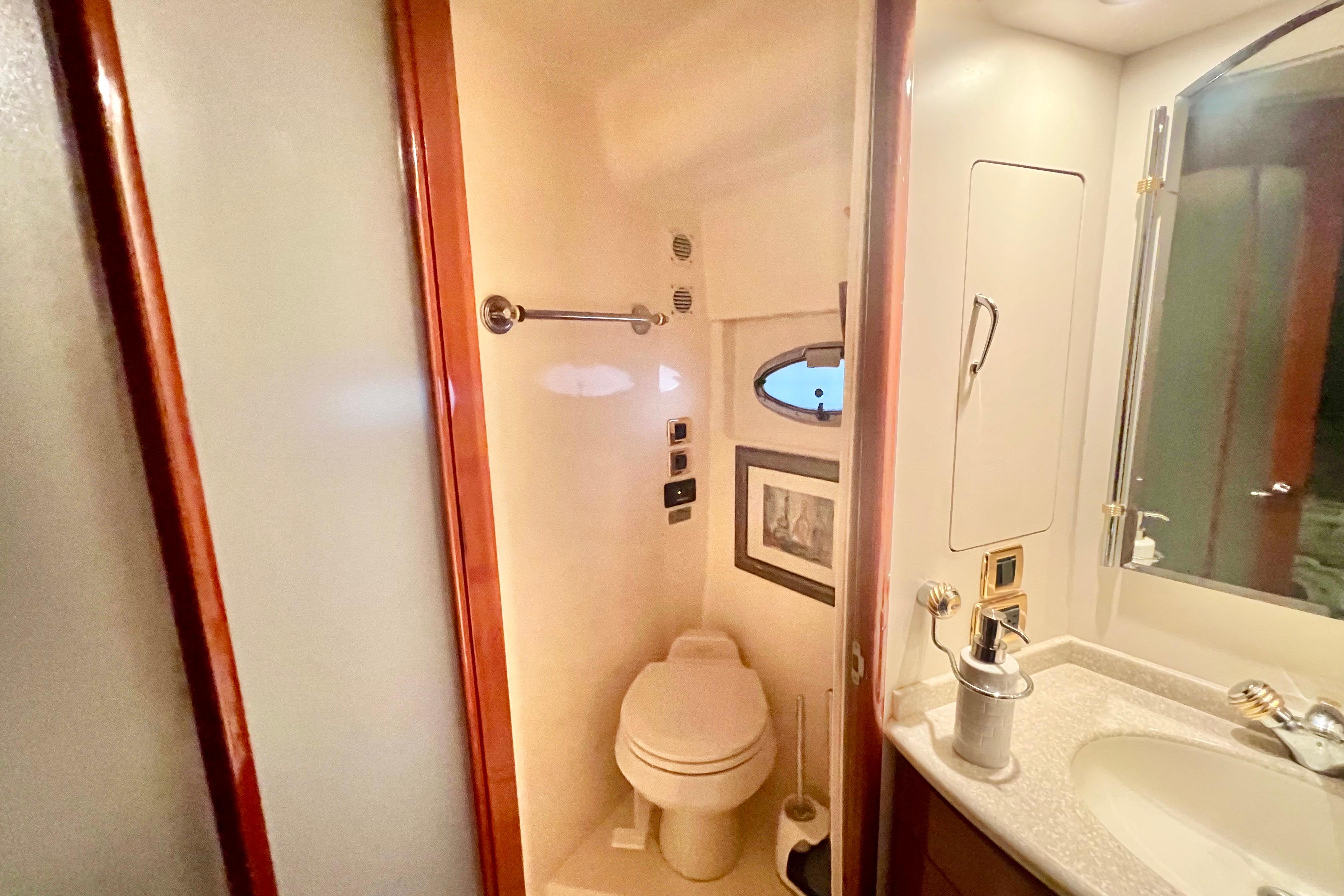 Bathroom interior of 2005 Carver 56 Voyager yacht, featuring toilet and sink.
