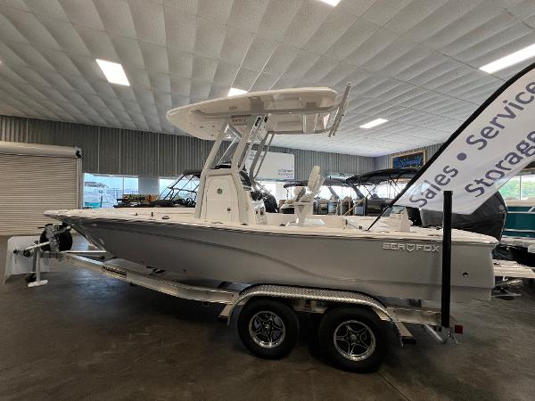 2024 Sea Fox 231 Bay boat on a trailer in a showroom.