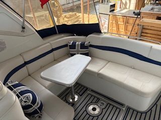 Interior of a 2007 Formula 34 Performance Cruiser with white and blue seating and a table.