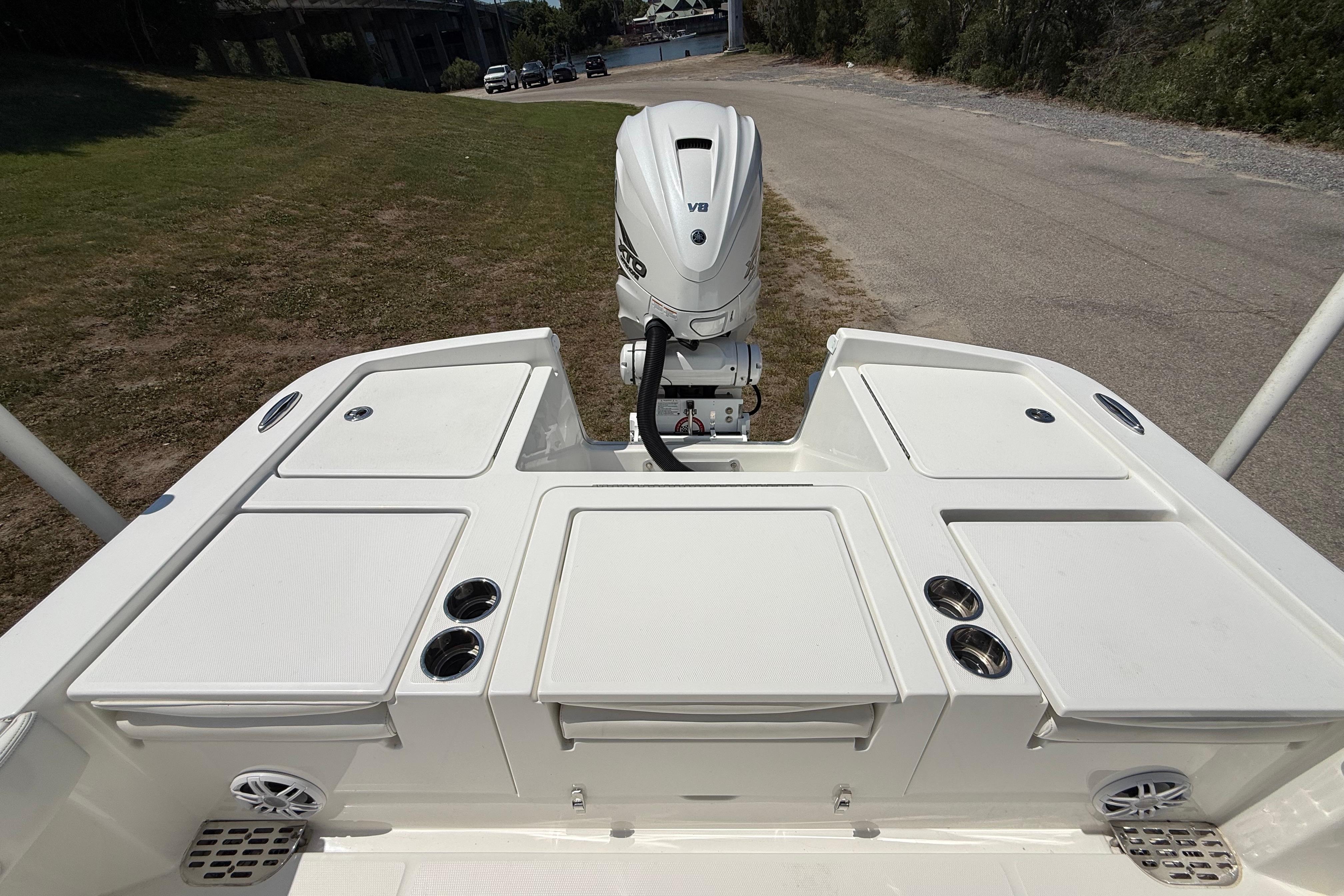 2023 Regulator 26XO boat stern view with outboard motor and storage compartments.