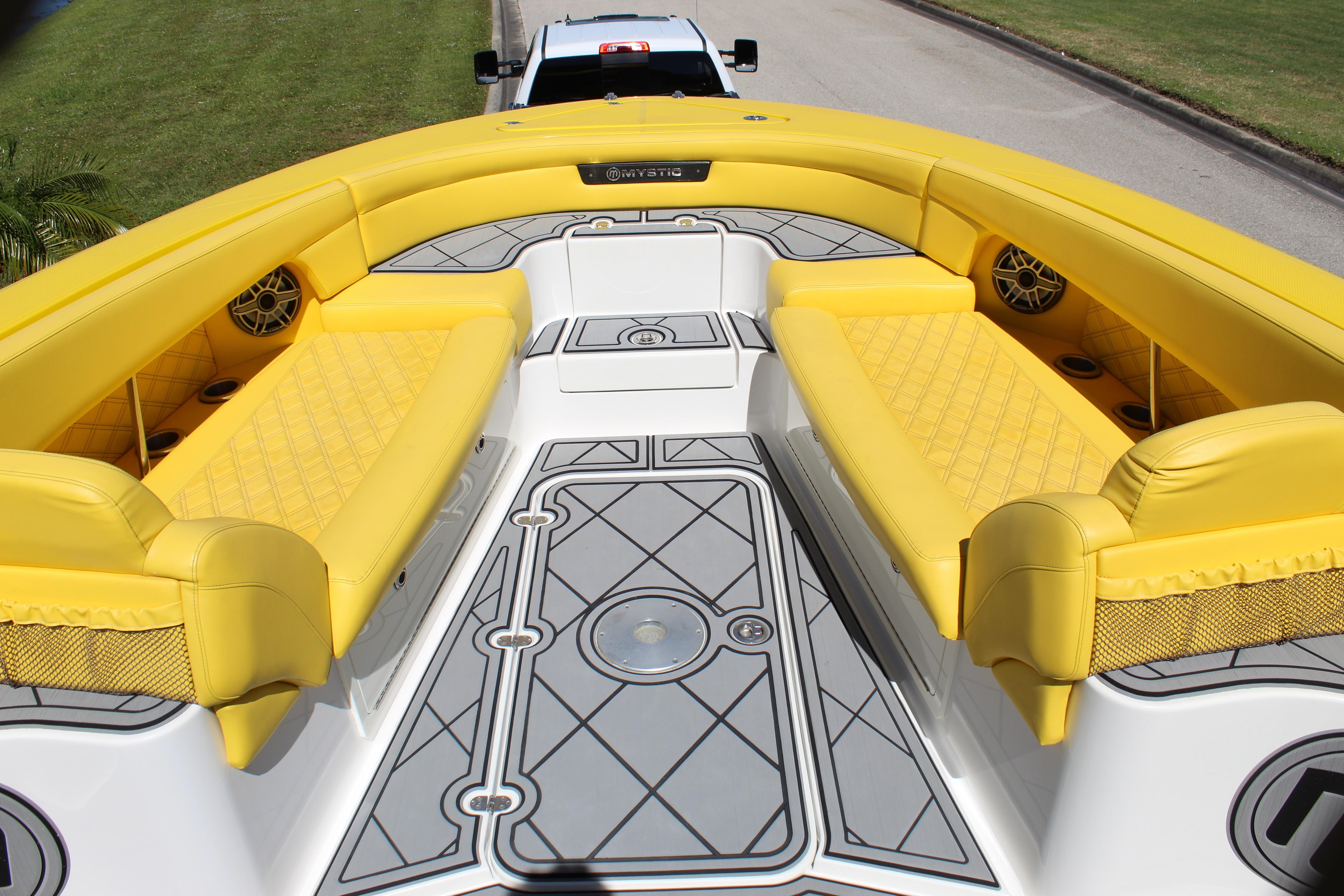 Yellow seating on 2021 Mystic M4200 boat deck, featuring stylish design and speaker system.