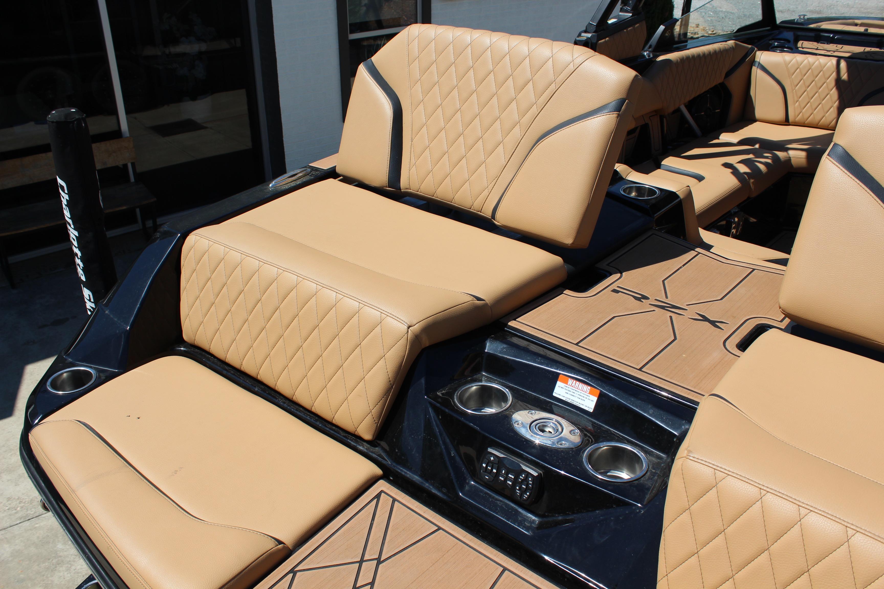 2022 Tigé 22RZX boat interior with tan quilted seats and cup holders.