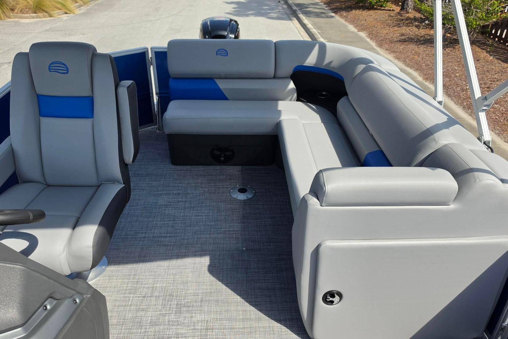 2026 Sun Tracker Party Barge 20 DLX interior with gray and blue seating.