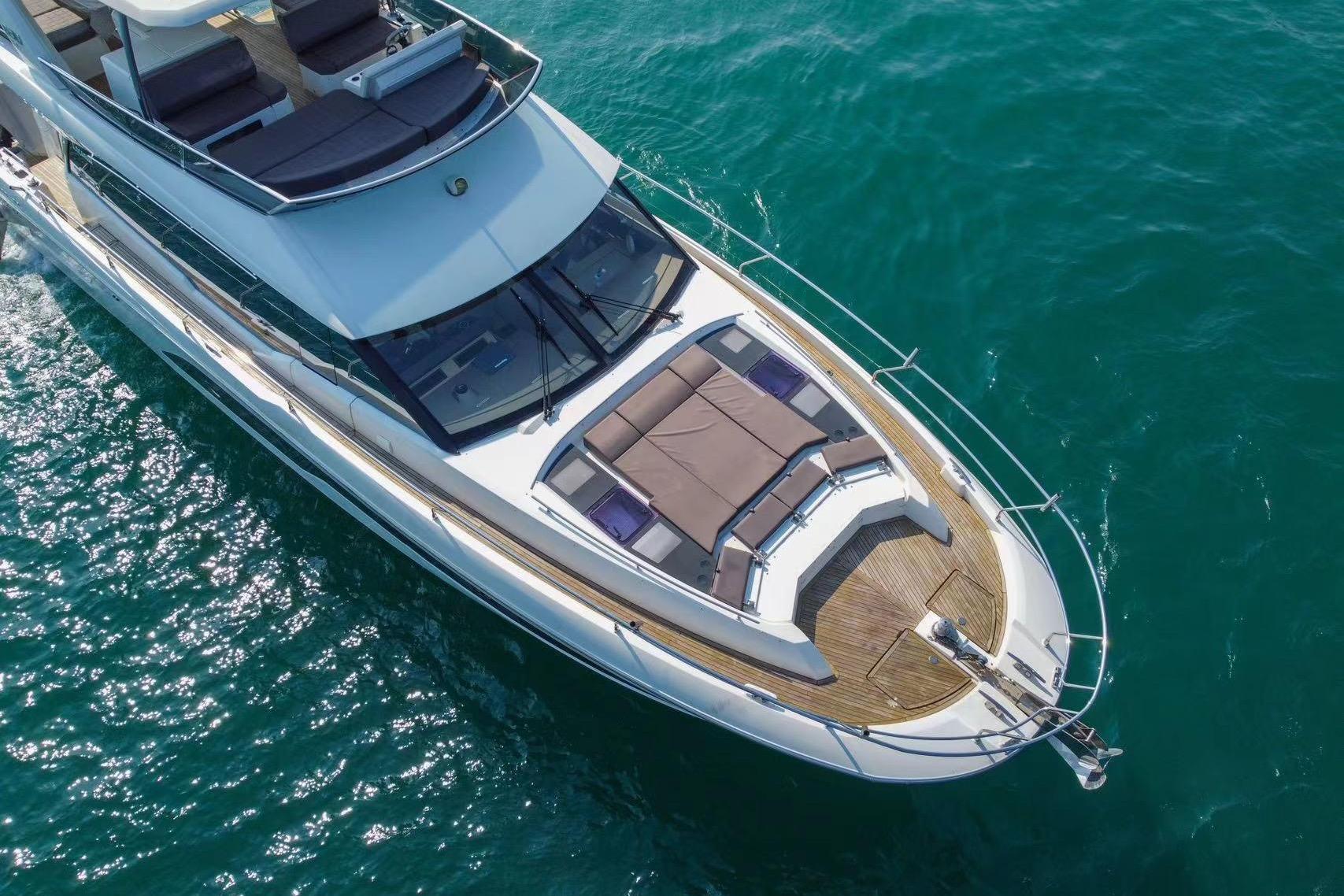 Luxurious 2019 Prestiage 630 yacht cruising on clear blue waters.
