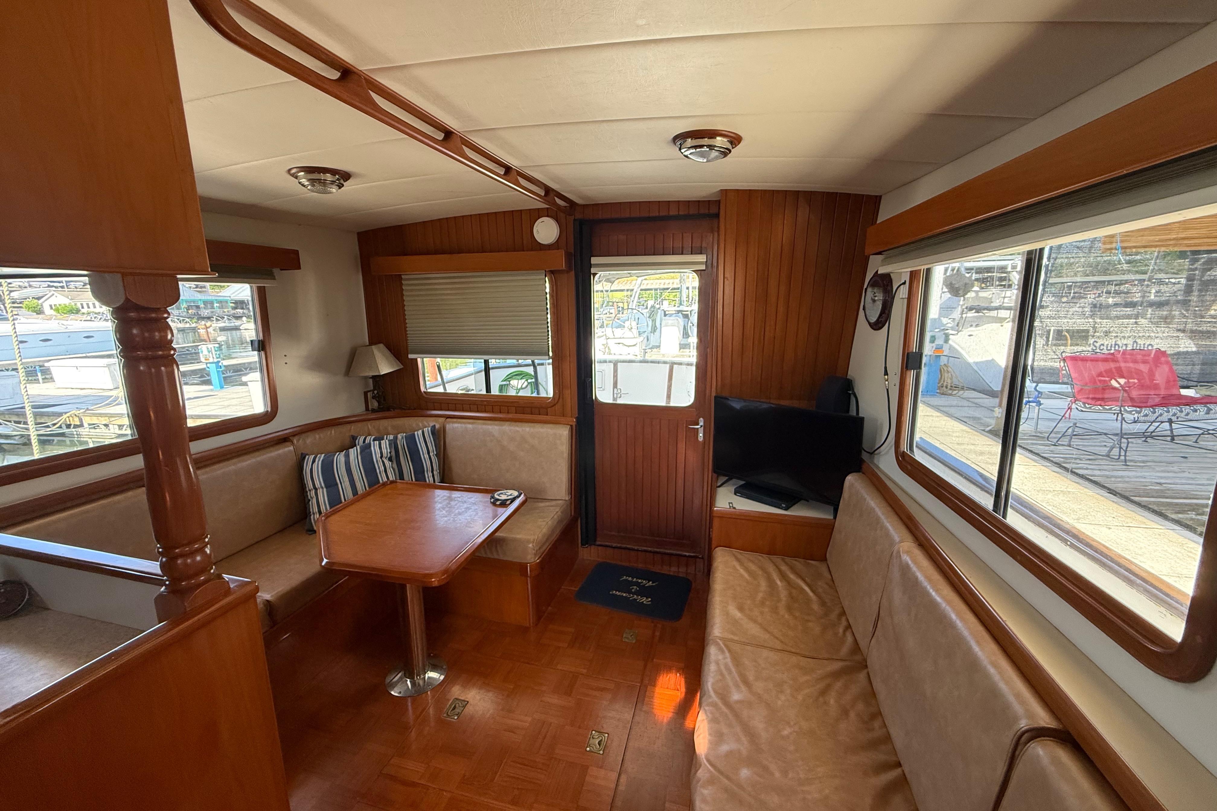 Interior of 2001 Kadey-Krogen 39 yacht with cozy seating and wooden finishes.