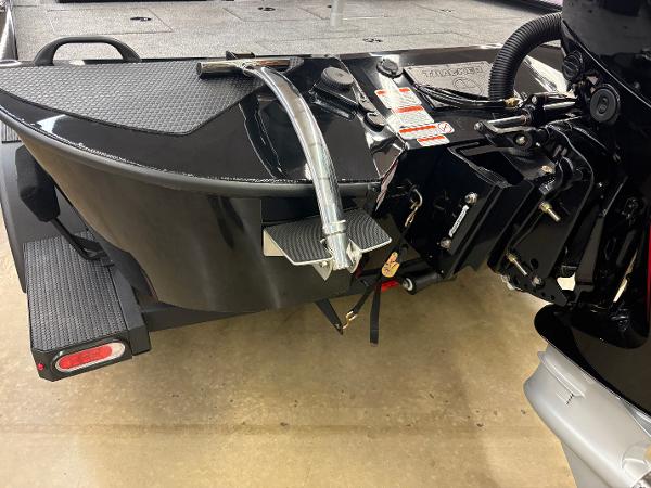 2025 Tracker Savage 215 boat trailer hitch and motor detail in a showroom.