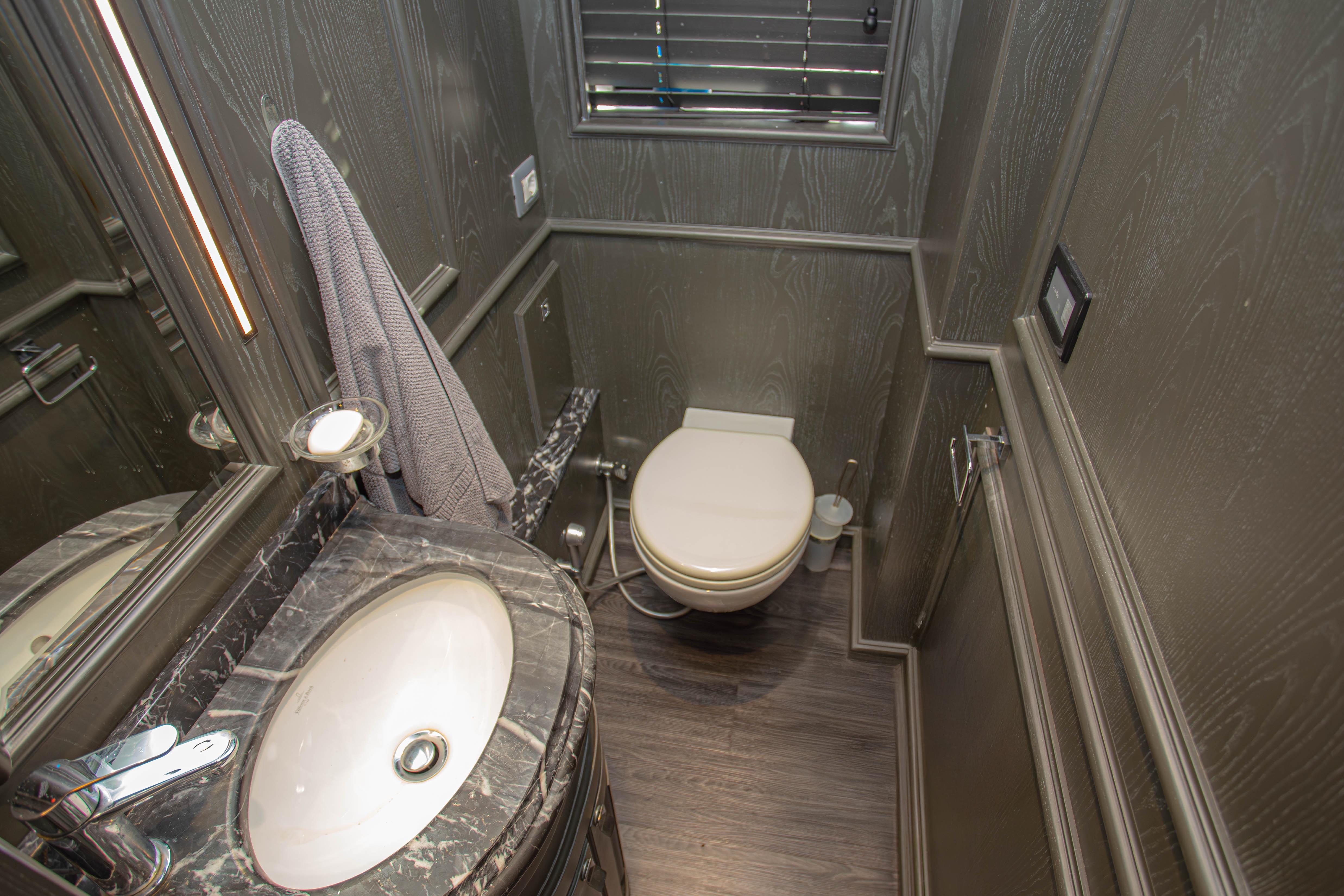 Luxurious bathroom on 2014 Fifth Ocean Yachts 24m Explorer Yacht with marble sink and modern fixtures.
