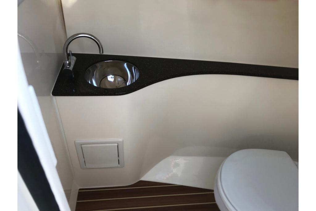 2023 Scout 240 Dorado boat interior with sink and toilet.
