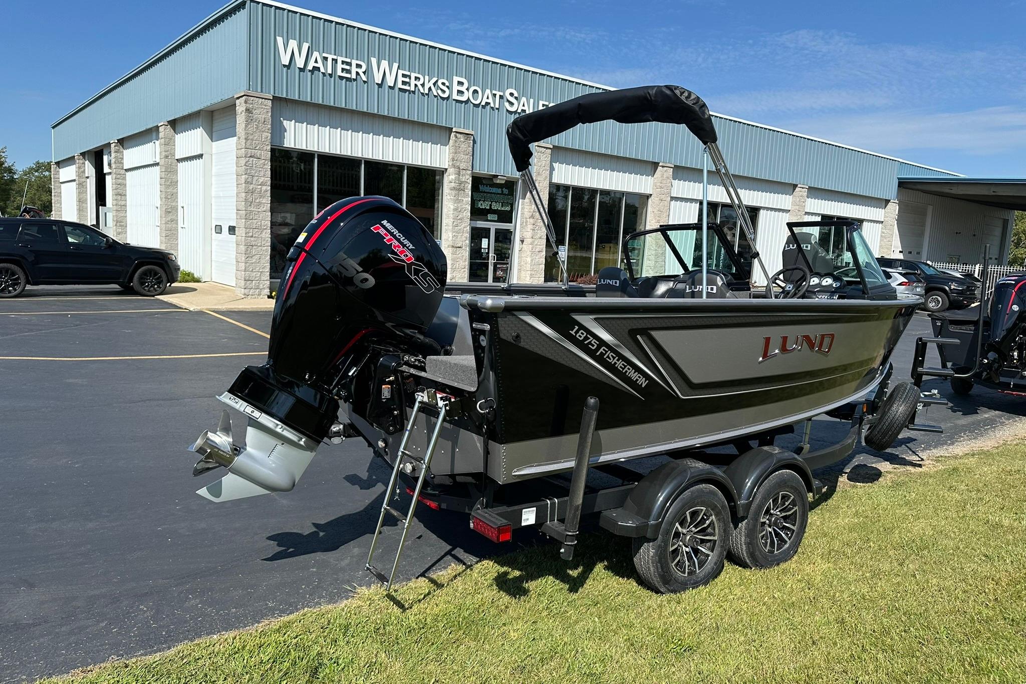 2026 Lund 1875 Fisherman boat on trailer outside Water Werks dealership.