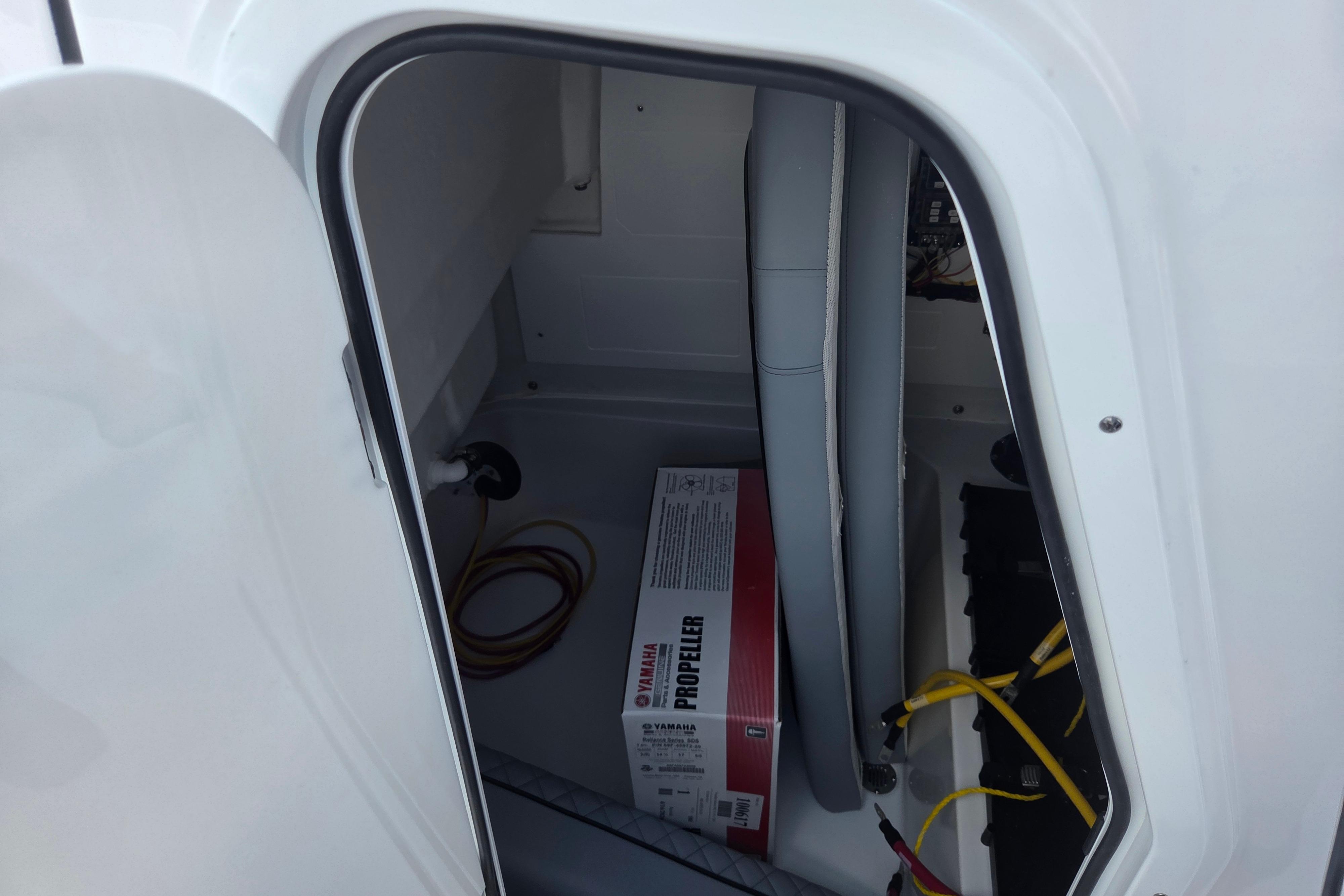 Storage compartment of 2026 Sportsman Open 212 Center Console with Yamaha propeller box.