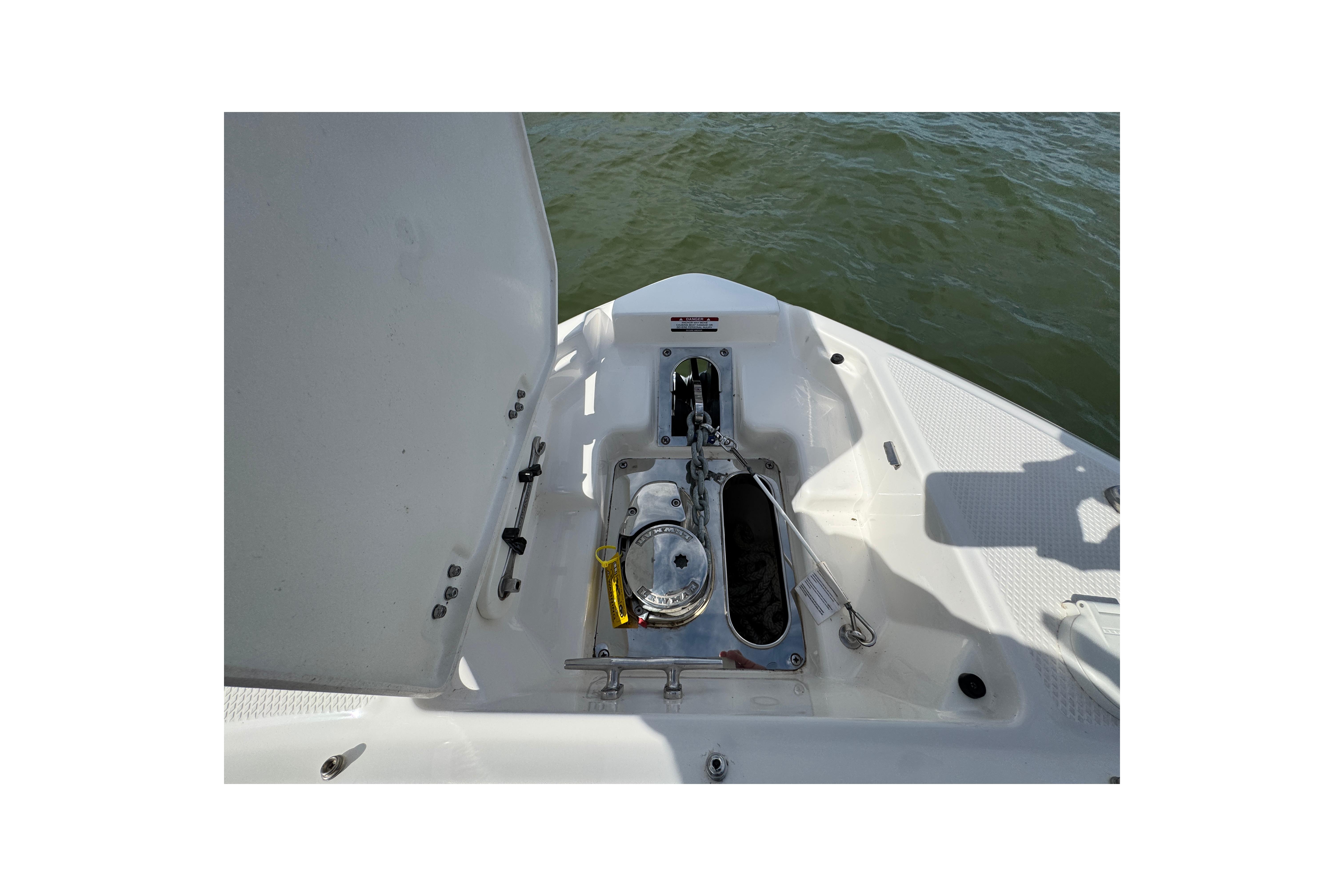 2023 Chaparral 26 Surf boat anchor compartment with water view.