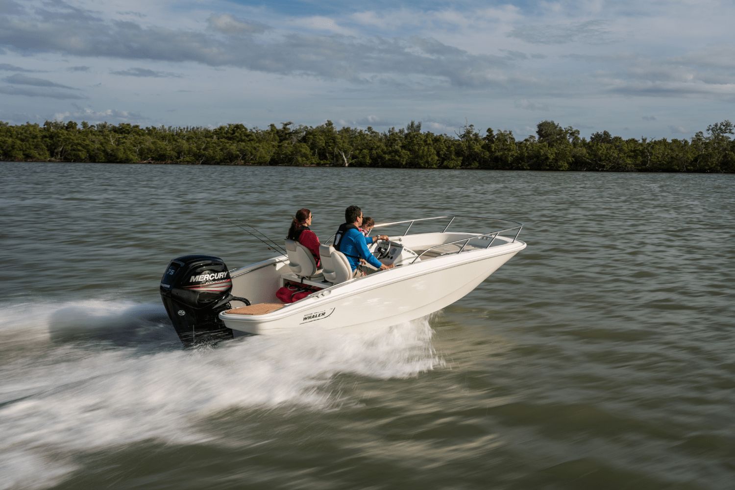 Two people ride a Boston Whaler 160 Super Sport on calm waters.