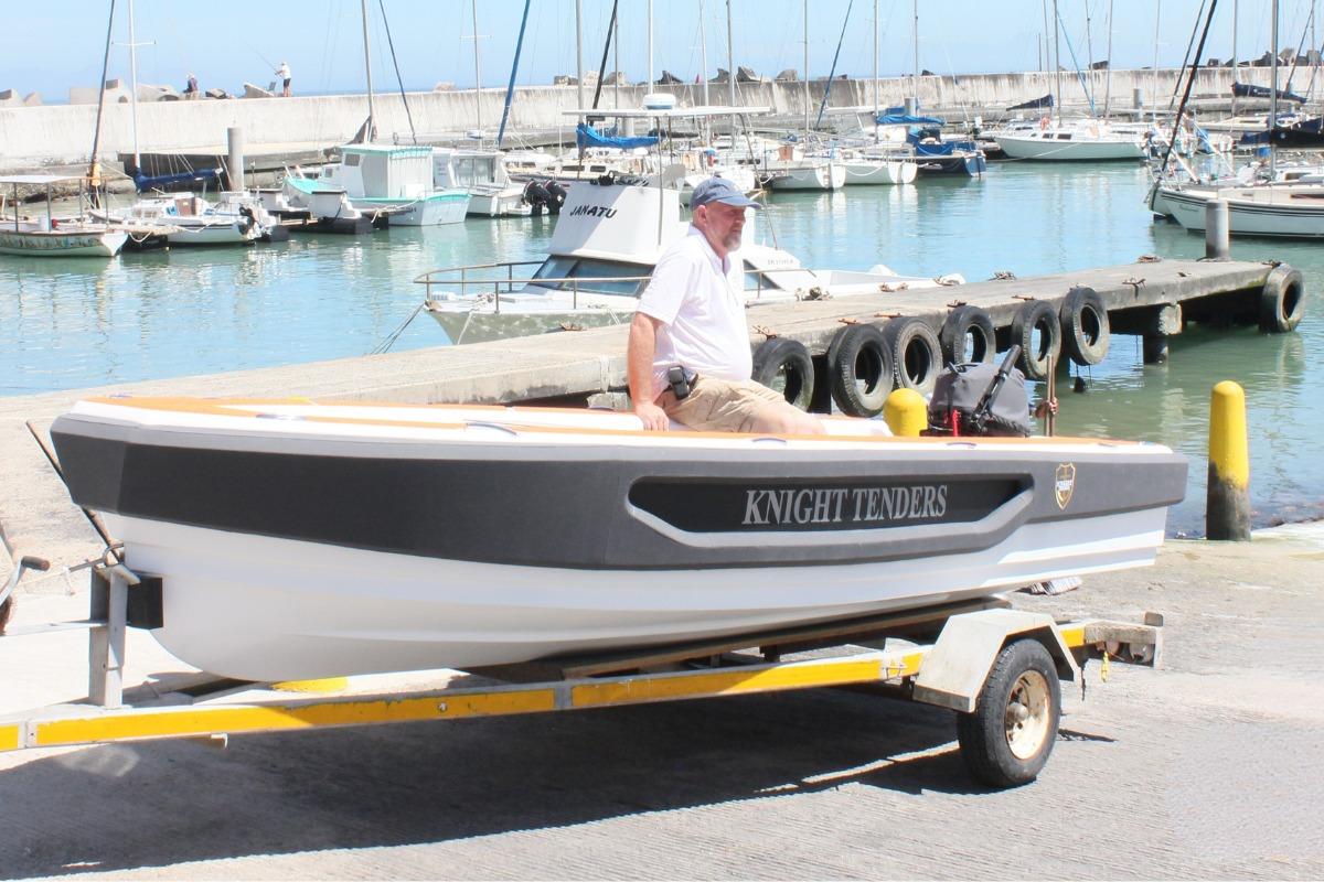 Man on 2026 Knight Tender Zerojet Electric Center Console boat at marina dock.