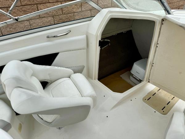 2006 Larson LXi 248 boat interior with white seating and storage compartment.