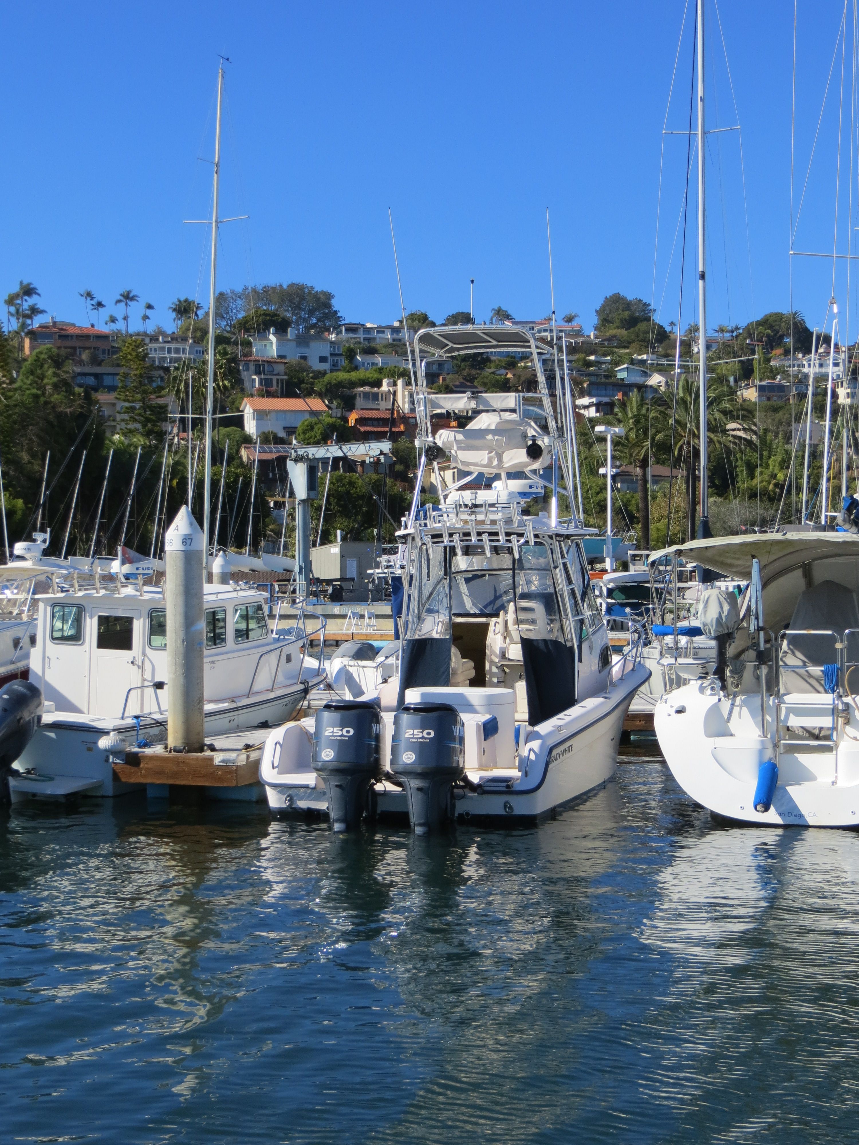 A 2007 Grady-White Sailfish 282 docked in a marina, surrounded by other boats.