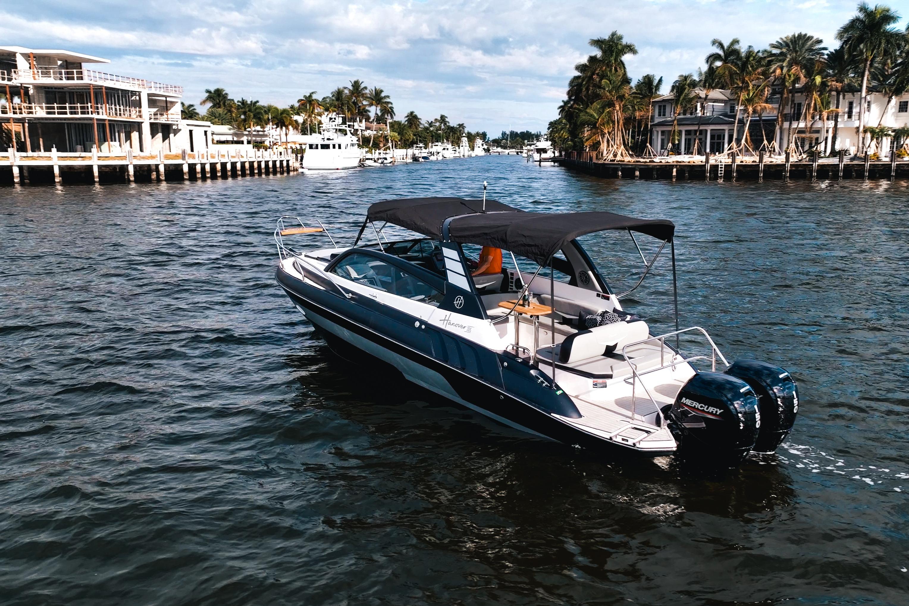 Luxury Hanover 305 boat cruising on a scenic waterway, 2027 model.