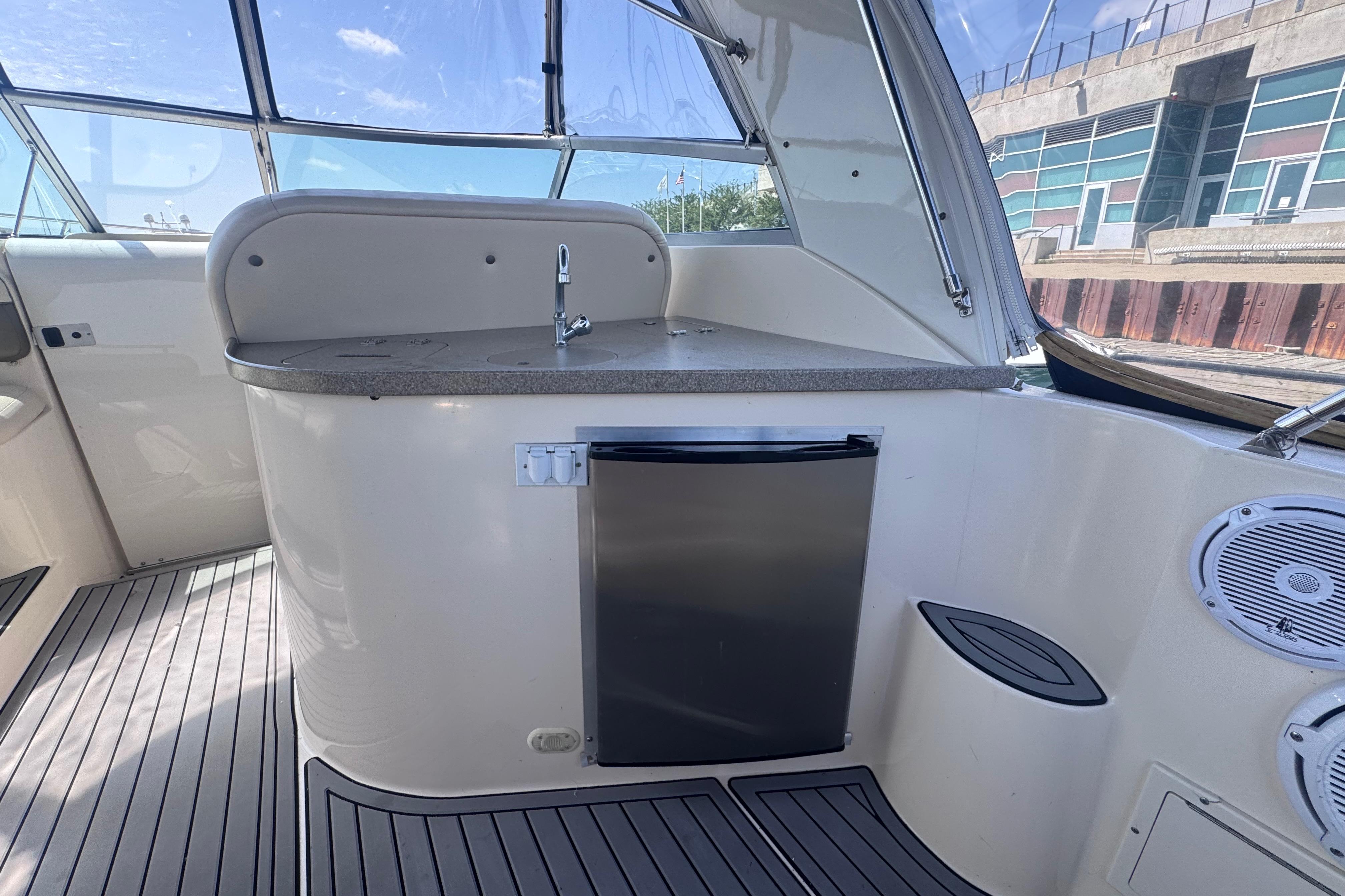 2003 Rinker Fiesta Vee 312 boat interior with kitchenette and mini fridge.