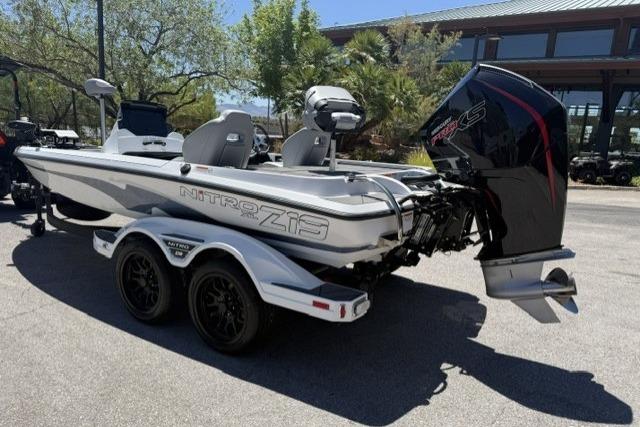 2026 Nitro Z19 XL Pro boat with dual axle trailer, parked outdoors.