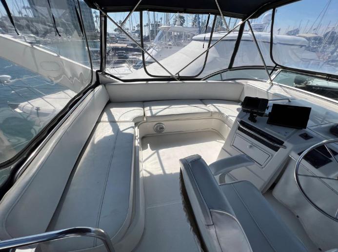 1997 Bayliner 3788 Command Bridge Motoryacht interior with seating and helm, docked at marina.
