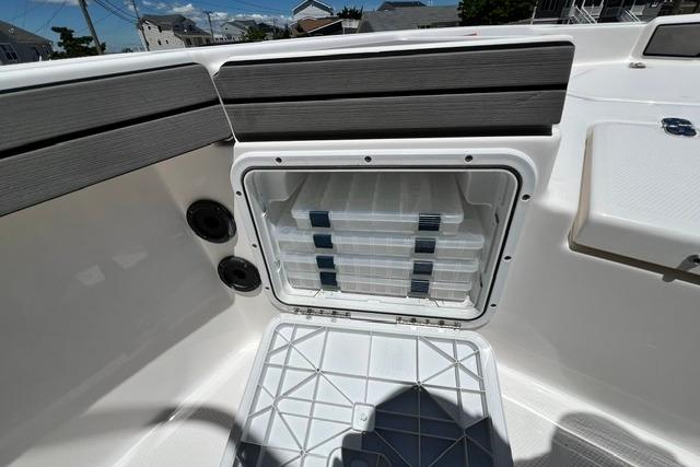 Storage compartment on a 2019 Yamaha Boats 190 FSH Sport, featuring organized tackle boxes.