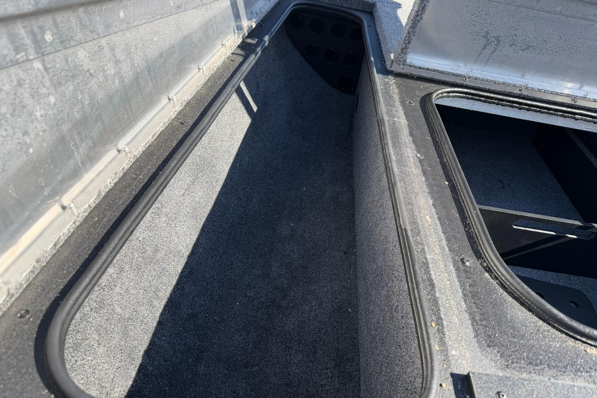 2024 Tracker Pro Team 175 TXW boat storage compartment, open and empty.