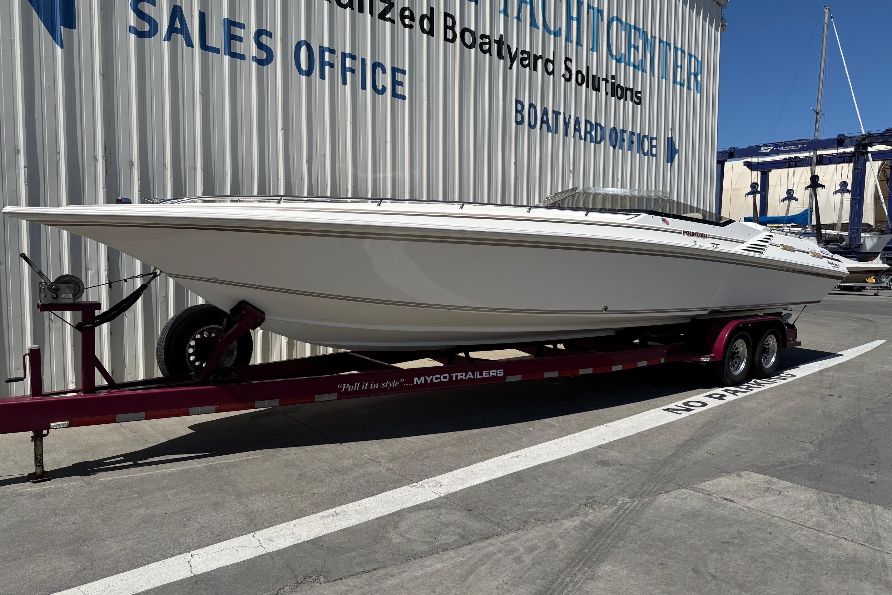 1998 Fountain 35 Lightning boat on trailer at yacht center sales office.
