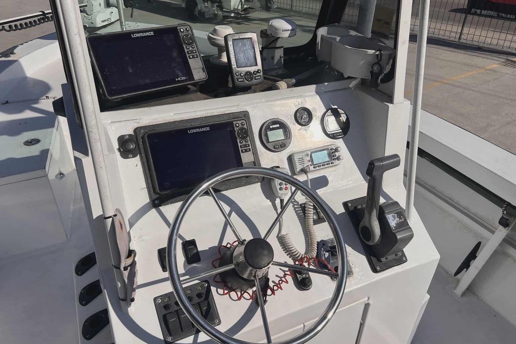 1997 Gravois 20CC boat dashboard with steering wheel, navigation screens, and control panel.