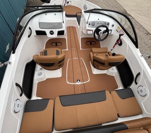 2025 Tahoe 185 S boat interior with tan and black seating, modern dashboard, and steering wheel.