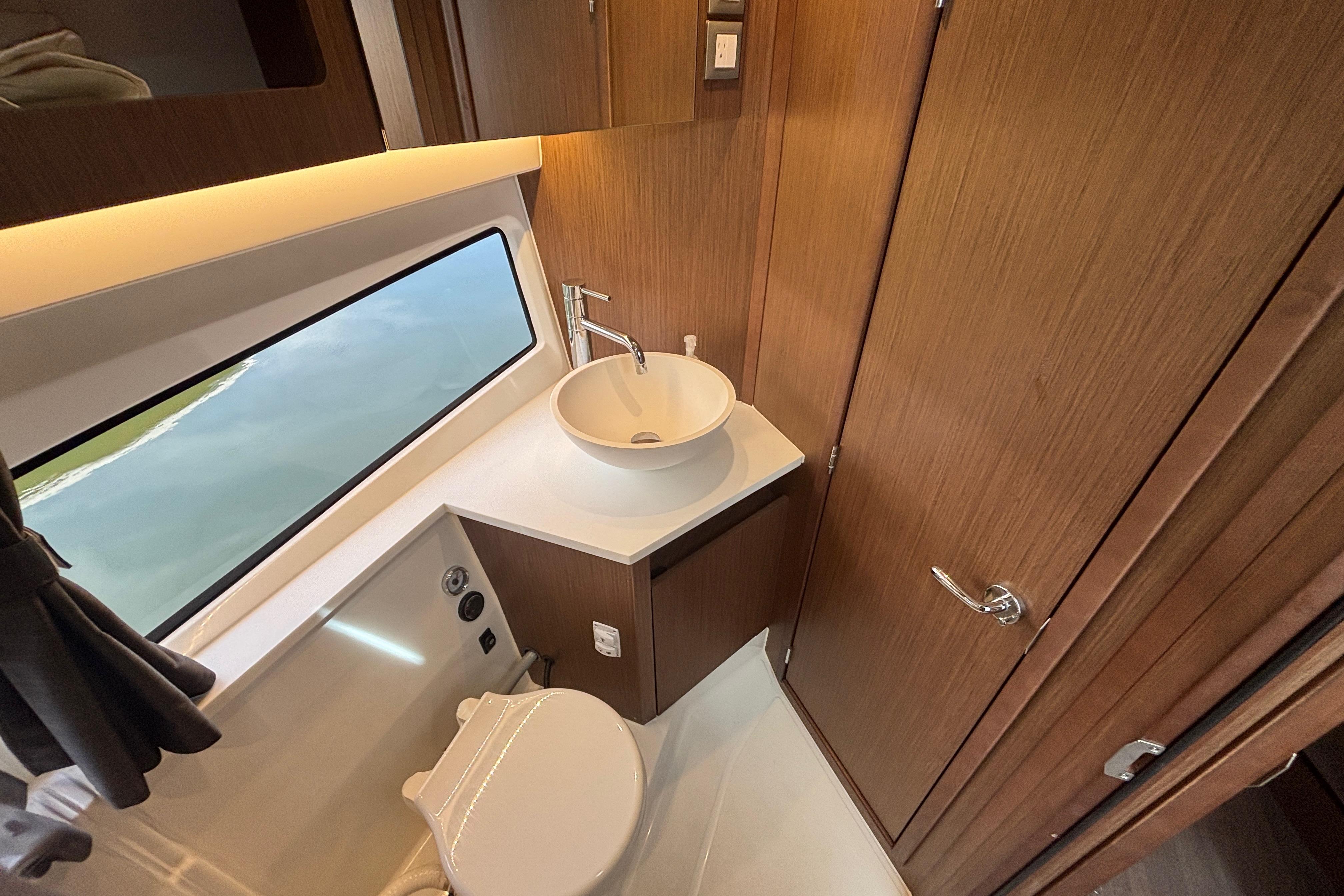 Luxurious bathroom interior of 2024 Beneteau Antares 11 yacht with modern fixtures.