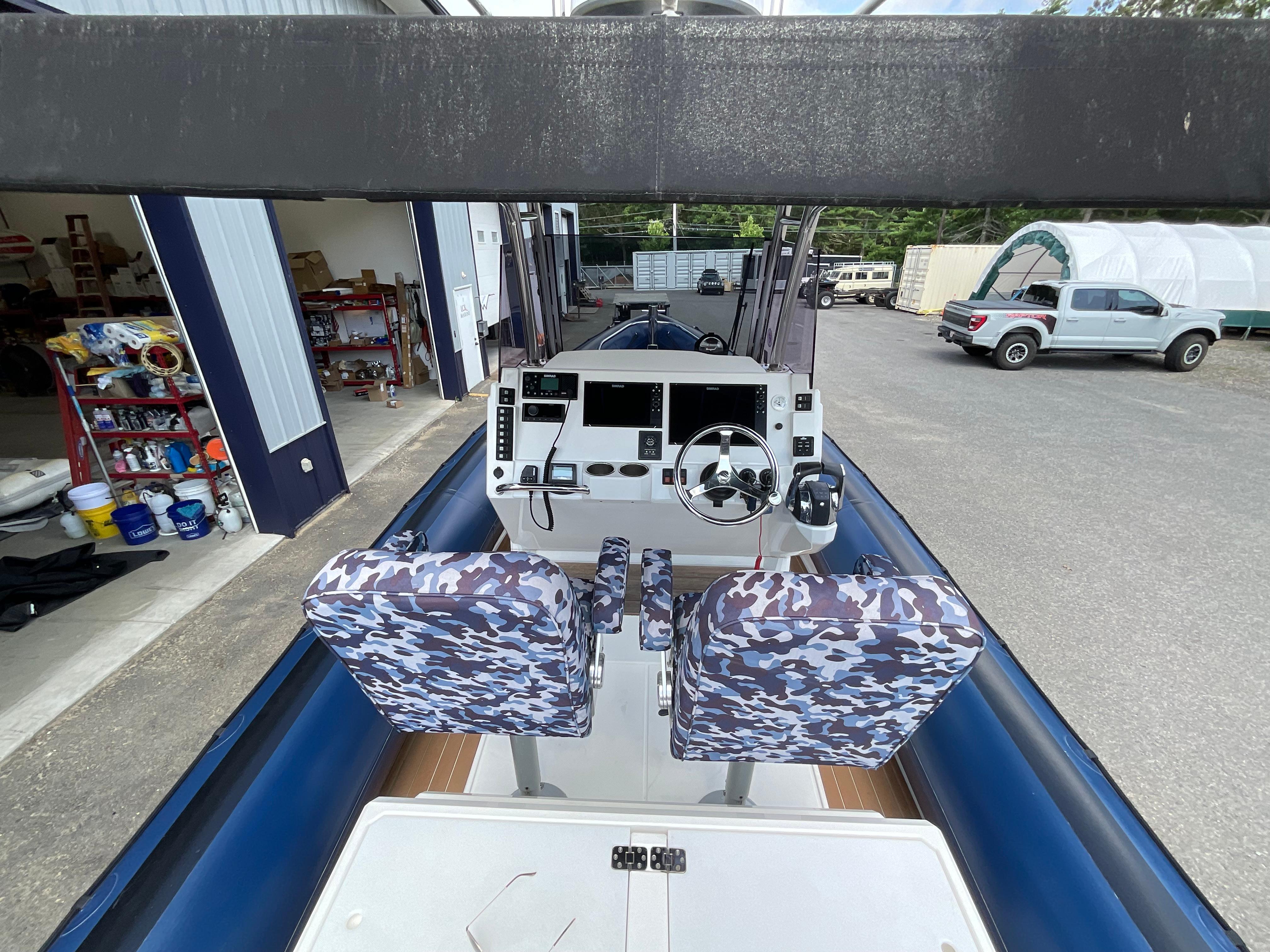 2019 Protector 310 Chase boat interior with camo seats and modern control panel.