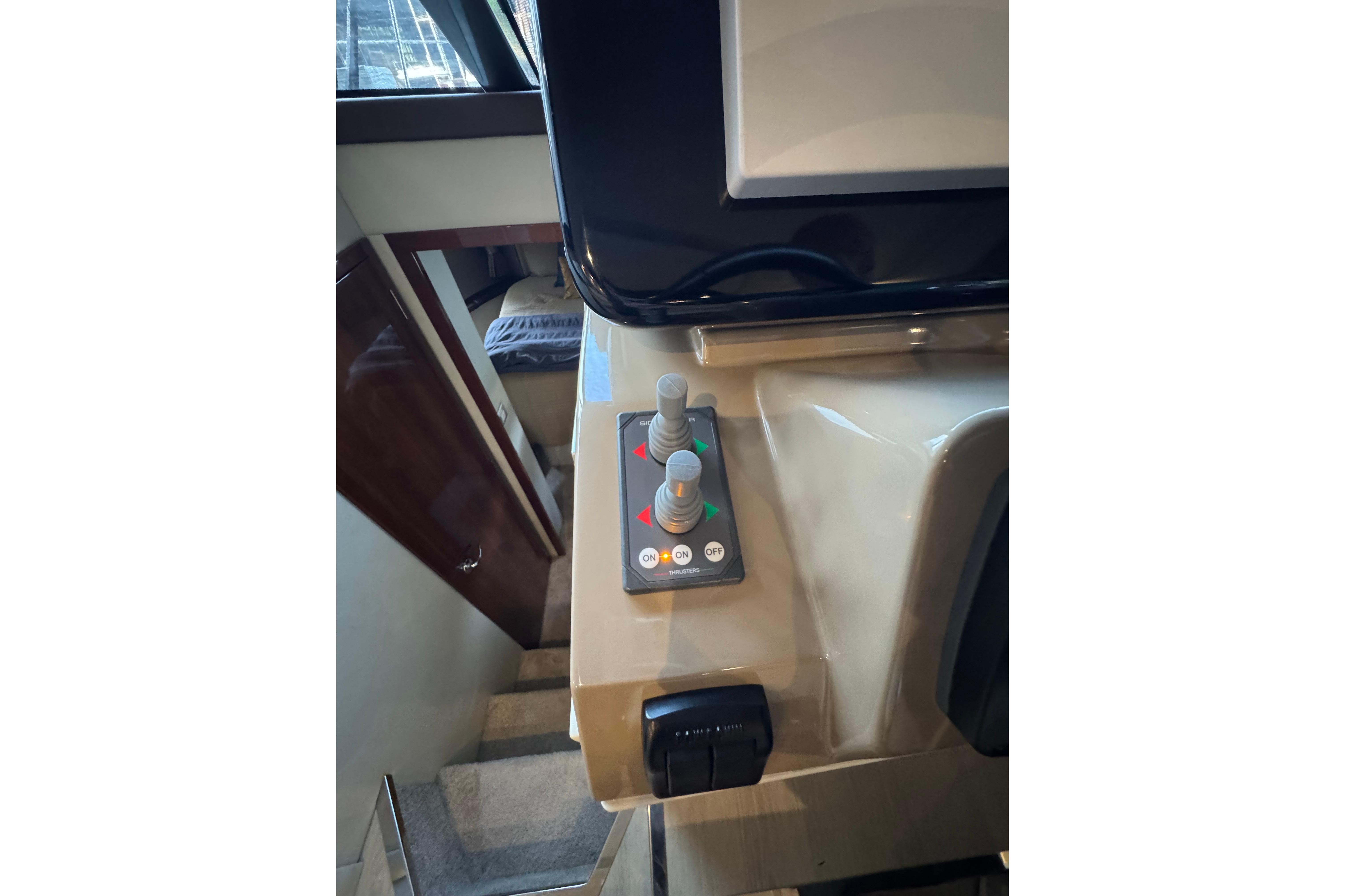 Control panel inside 2016 Carver C37 Coupe yacht, featuring switches and knobs.