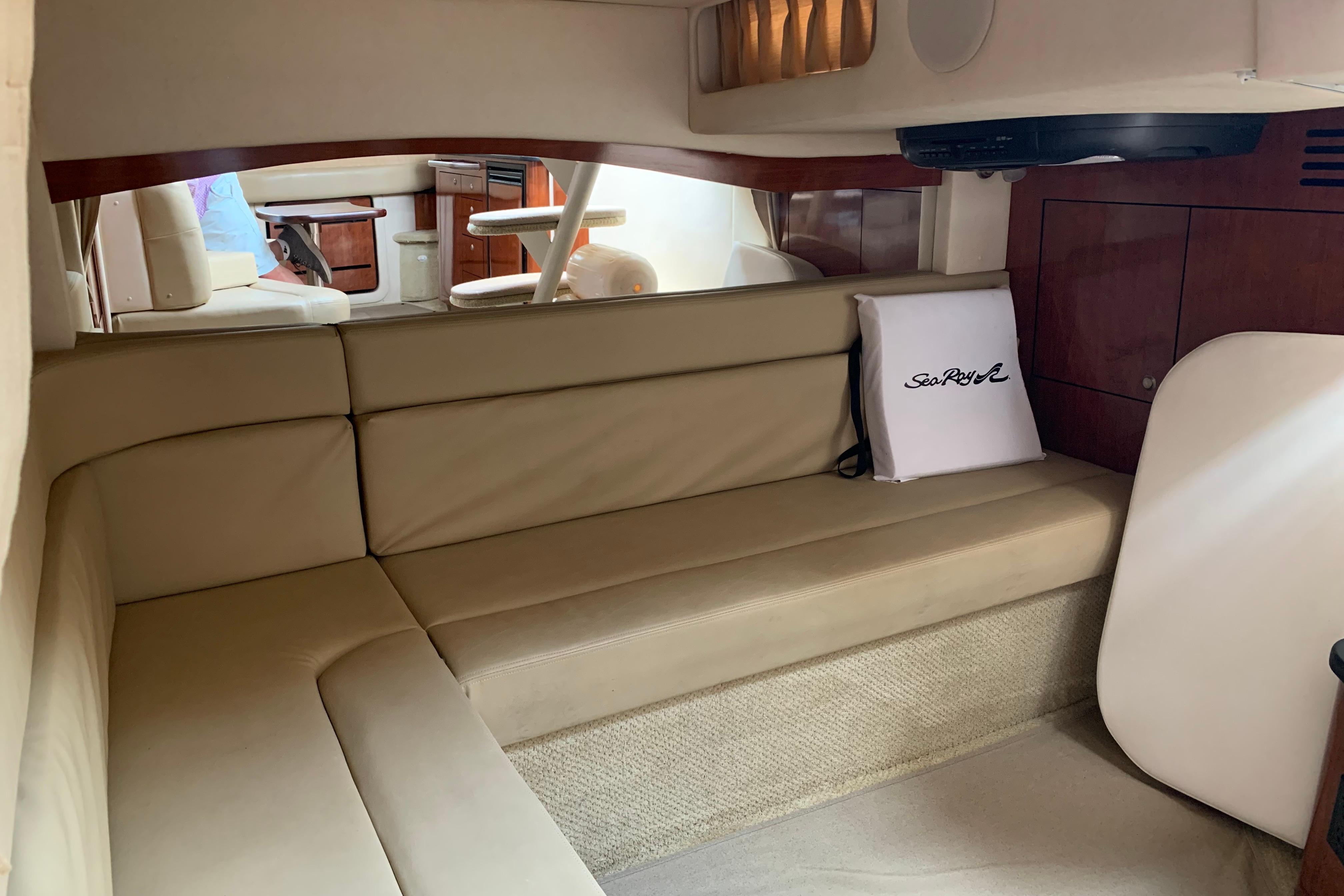 Interior of 2007 Sea Ray 340 Sundancer with beige seating and wooden cabinetry.