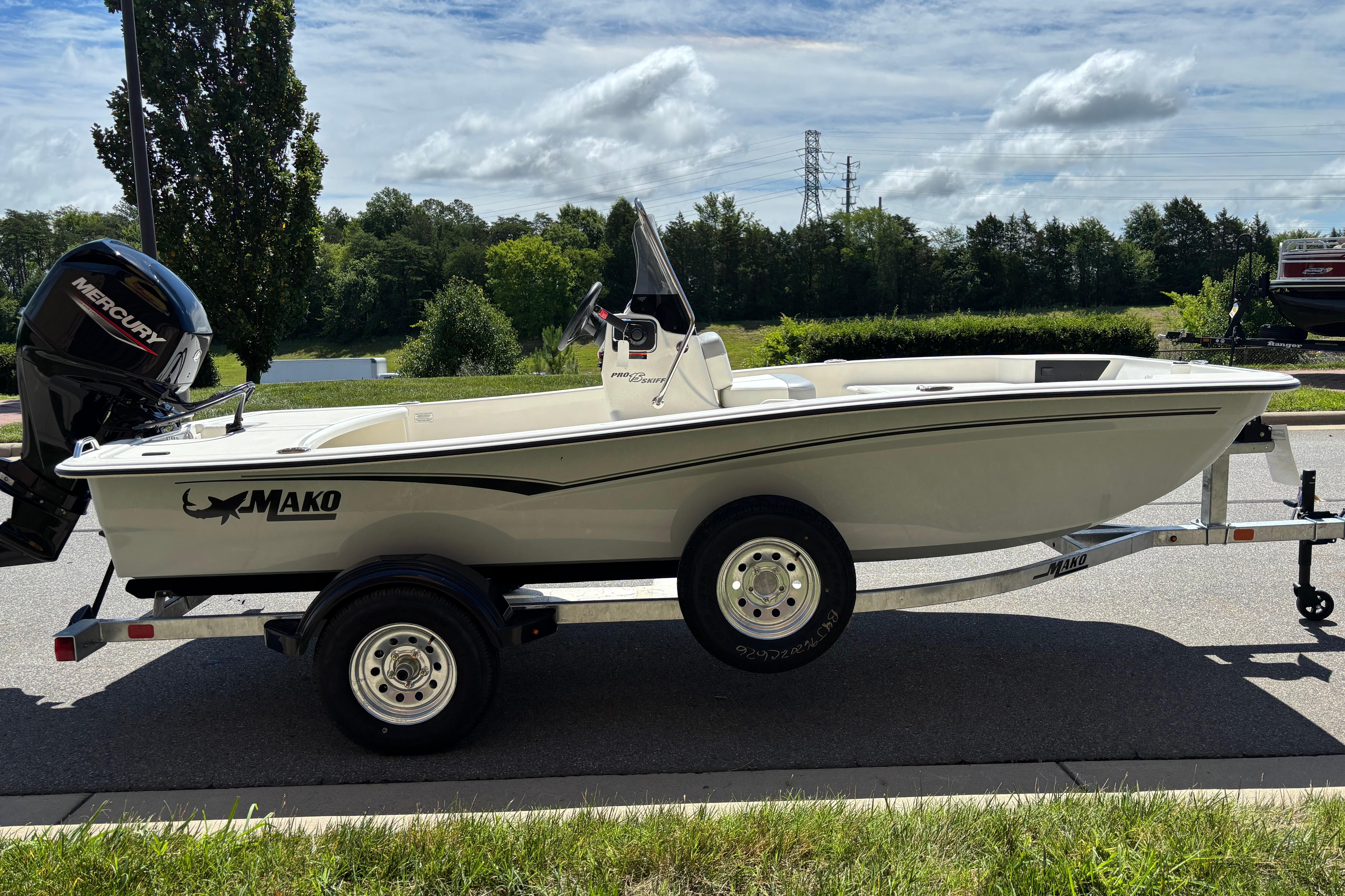 2026 Mako Pro Skiff 15 CC boat on trailer, featuring Mercury outboard motor.